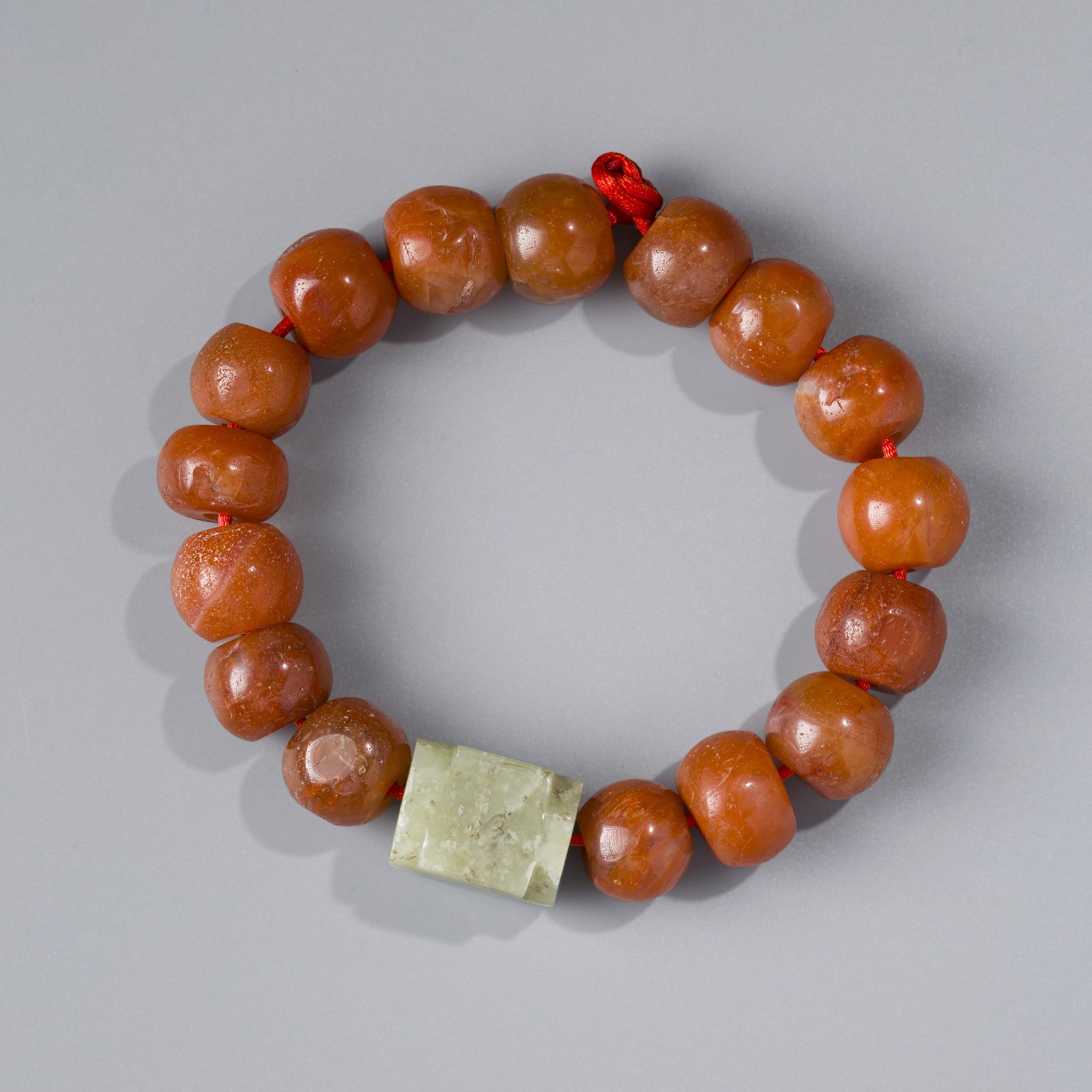 Tibetan Antique Nanhong Agate Bead Bracelet with Chinese Jade Tube Pendant: A striking antique bracelet featuring Nanhong agate beads, paired with a Chinese jade tube-shaped pendant.Weight:128 grams