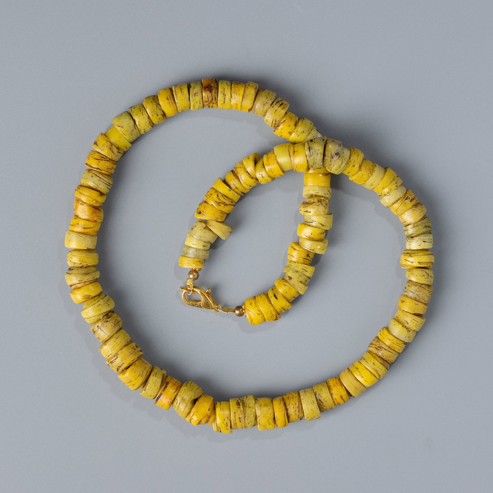 Antique Yellow Glass Trade Beads Necklace: An antique necklace featuring vibrant yellow glass trade beads. Length: 20 inchesWeight: 89 gramsBead Size: Approx. 1 x 0.6 cm