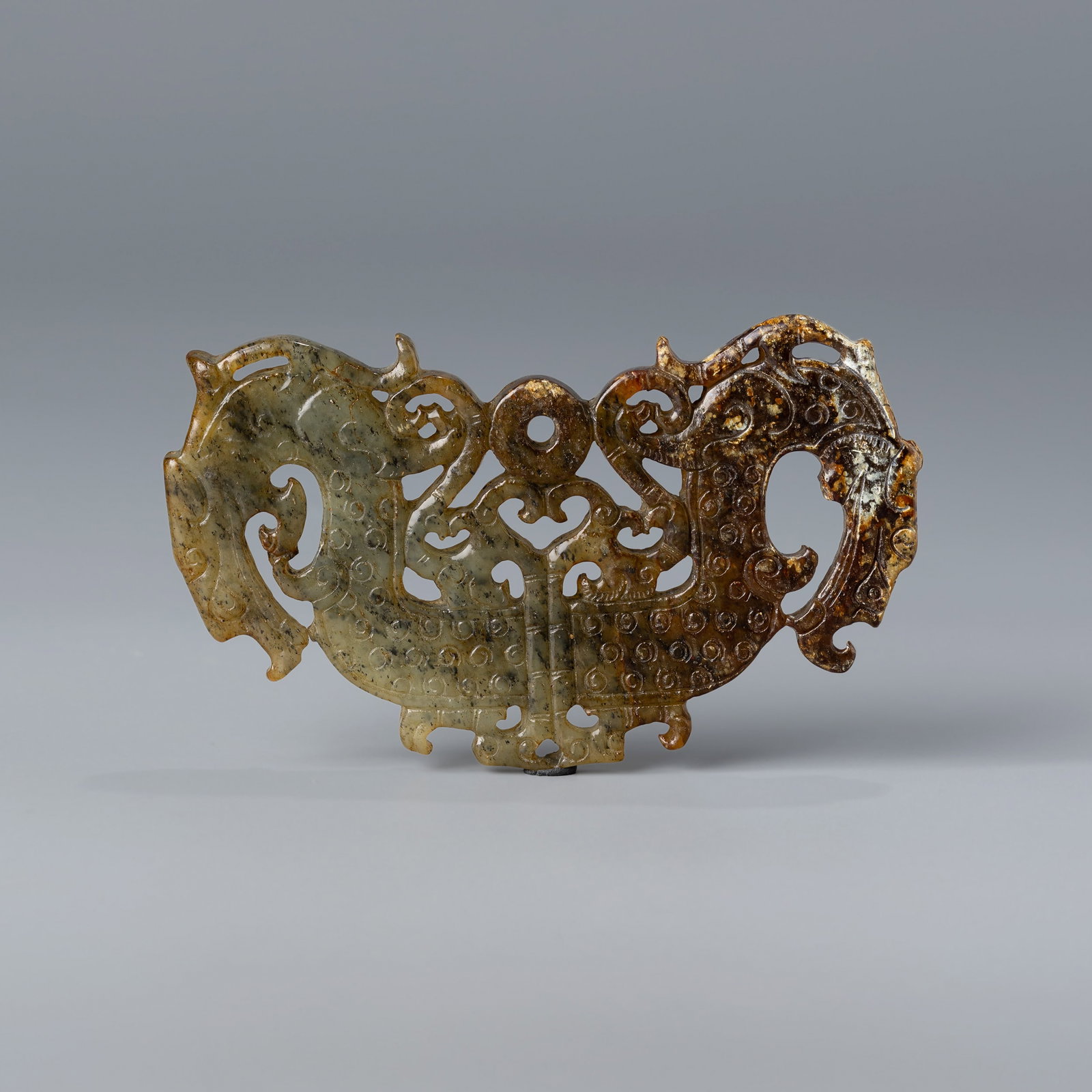 Ancient Chinese Liangzhu Culture Hetian Jade Pendant Depicting Dragon Motif: A finely carved Hetian jade pendant from the ancient Liangzhu culture, depicting a stylized dragon motif.Size: 9 x 5.2 cmWeight: 41 grams