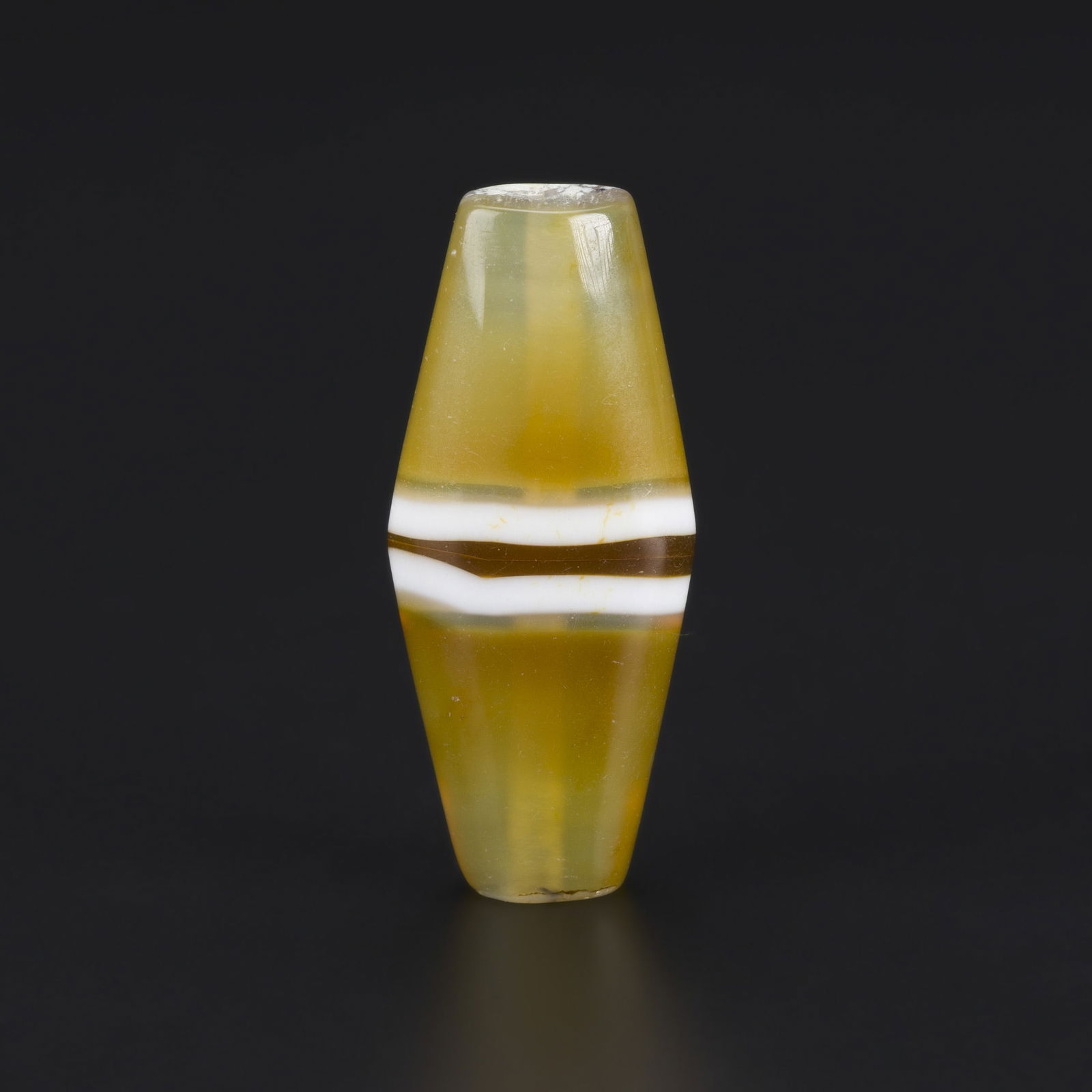 Asiatic Near Eastern Banded Agate Bead — Rare Striped Pattern: A Near Eastern agate bead featuring a rare striped pattern and natural banding. Size Detail: 1.7 x 3.9cm Weight: 10gram