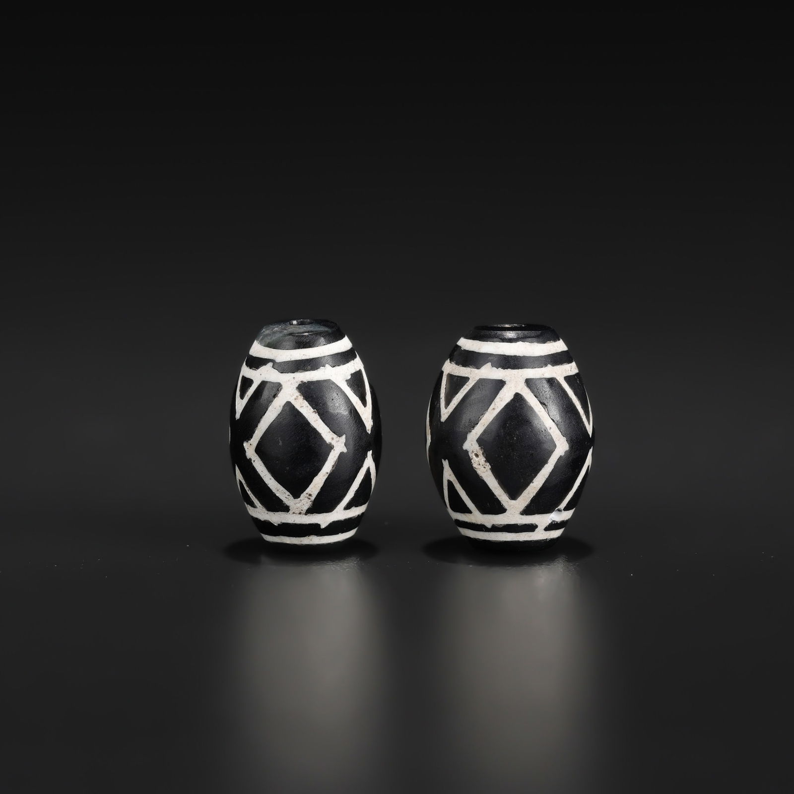 Pair of Tibetan Dzi Beads — Rare Eyes Pattern: A pair of Tibetan Dzi beads featuring a rare eyes pattern. Total Weight: 7gram