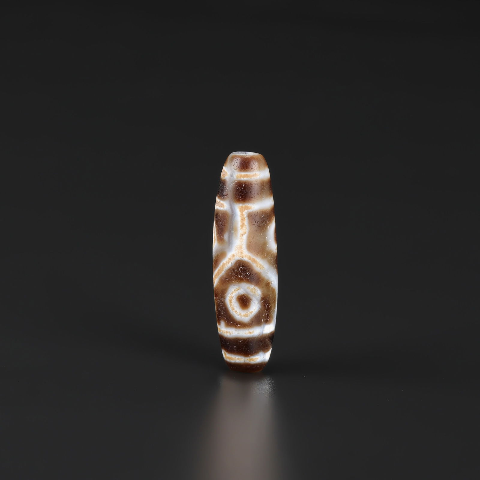 Himalayan Tibetan 6-Eyes Agate Dzi Bead — Rare Pattern: A Himalayan Tibetan agate Dzi bead featuring a rare 6-eyes pattern. Size Detail: 1.3 x 4.7cm Weight: 13gram