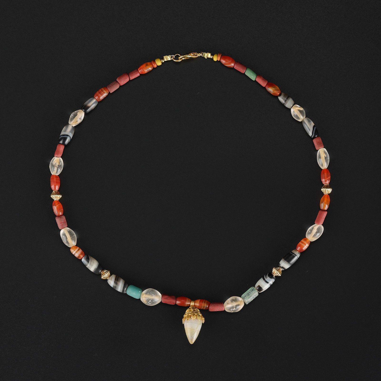 Bactrian Necklace with Agate Mounted in Gold and Carnelian & Agate Beads: An Ancient Bactrian necklace composed of carnelian and agate beads, featuring an agate mounted in gold. Length: 17in Total Weight: 25gram