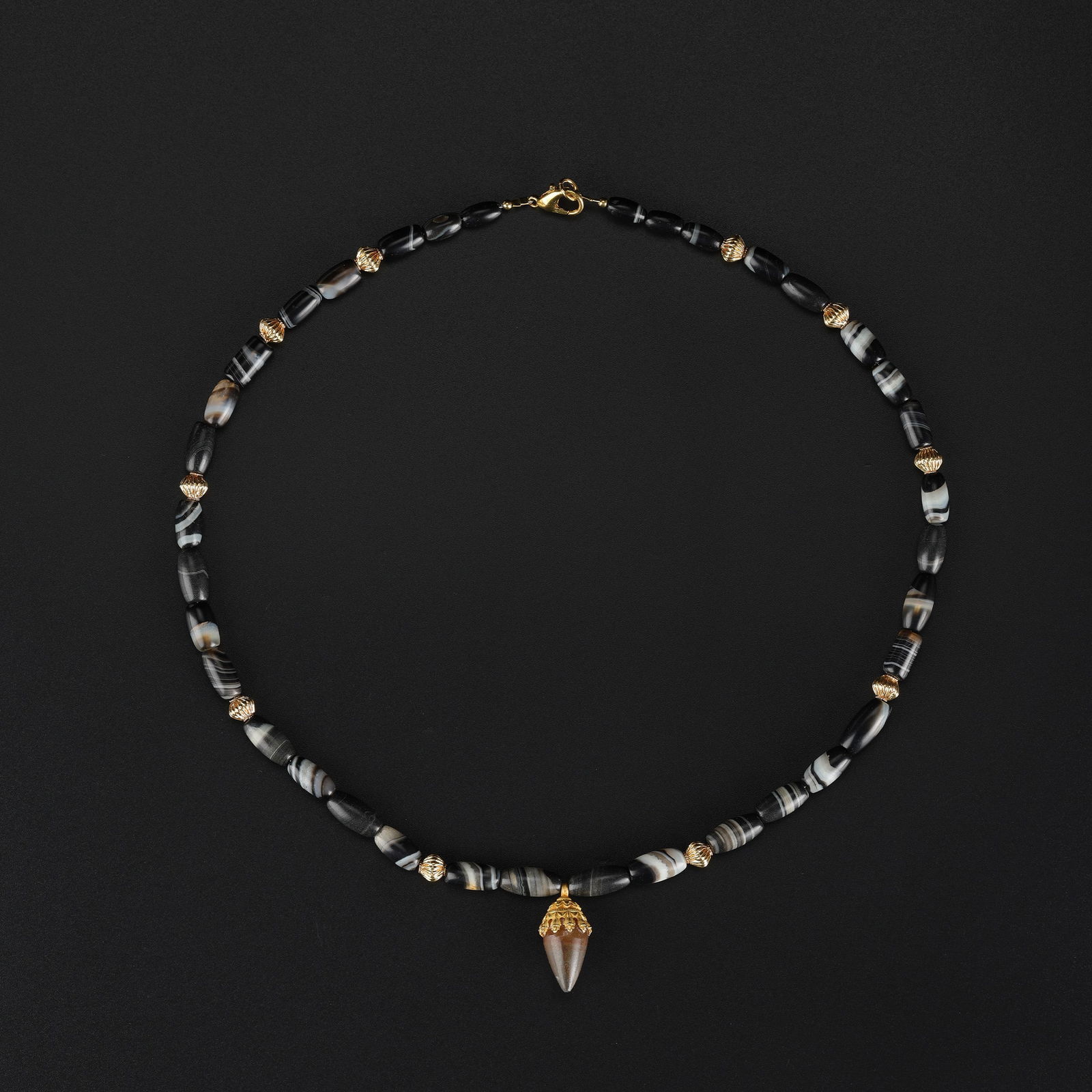 Ancient Himalayan-Tibetan Agate Beads Necklace with Carnelian Mounted in Gold: An Ancient Himalayan-Tibetan necklace composed of agate beads, accented with gold, featuring a carnelian stone mounted in gold. Length: 20in Total Weight: 33gram