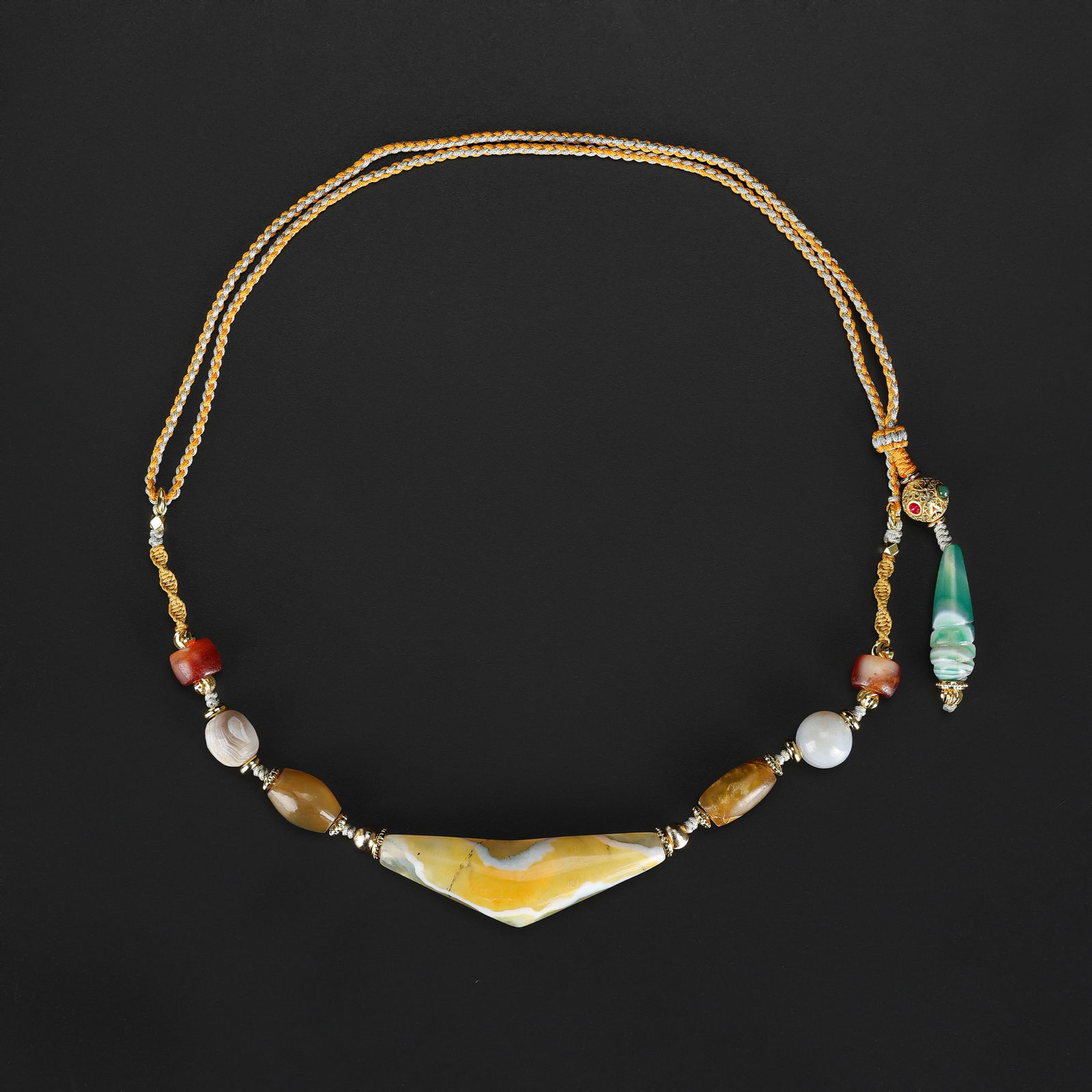 Antique Mixed-Material Beads Necklace with Intricate Handmade Design: Antique necklace featuring assorted beads in mixed materials, hand-strung with careful attention to design and arrangement. Each bead thoughtfully positioned to create a harmonious and visually striki