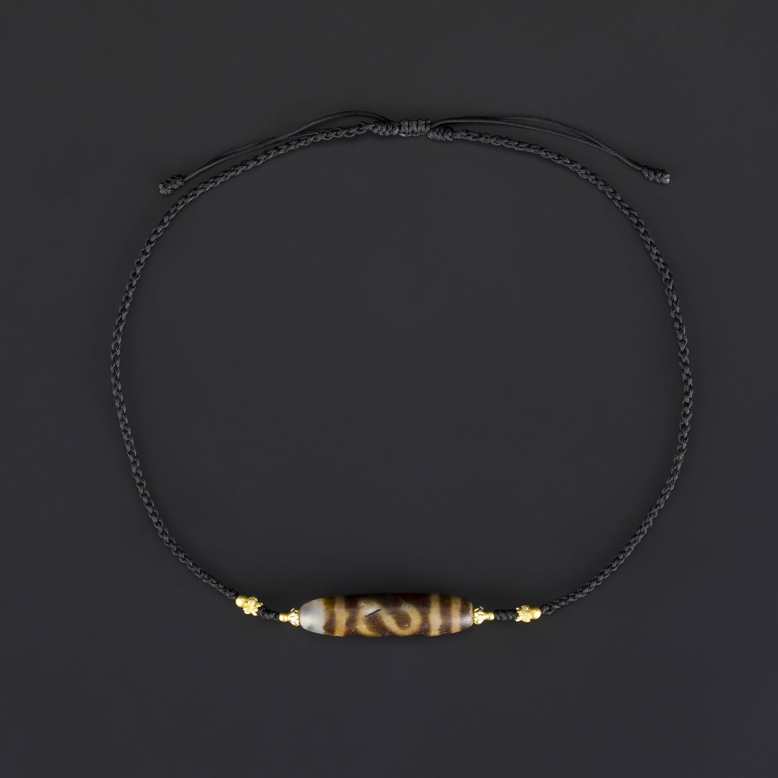 Rare Pattern Coffee-Colored Tibetan Dzi Bead Necklace – Handcrafted Design: Tibetan Dzi bead in a rich coffee color, featuring a rare and unique pattern, crafted into a finished necklace. Hand-knotted on soft fabric with careful attention to design. Total Weight: 13gram