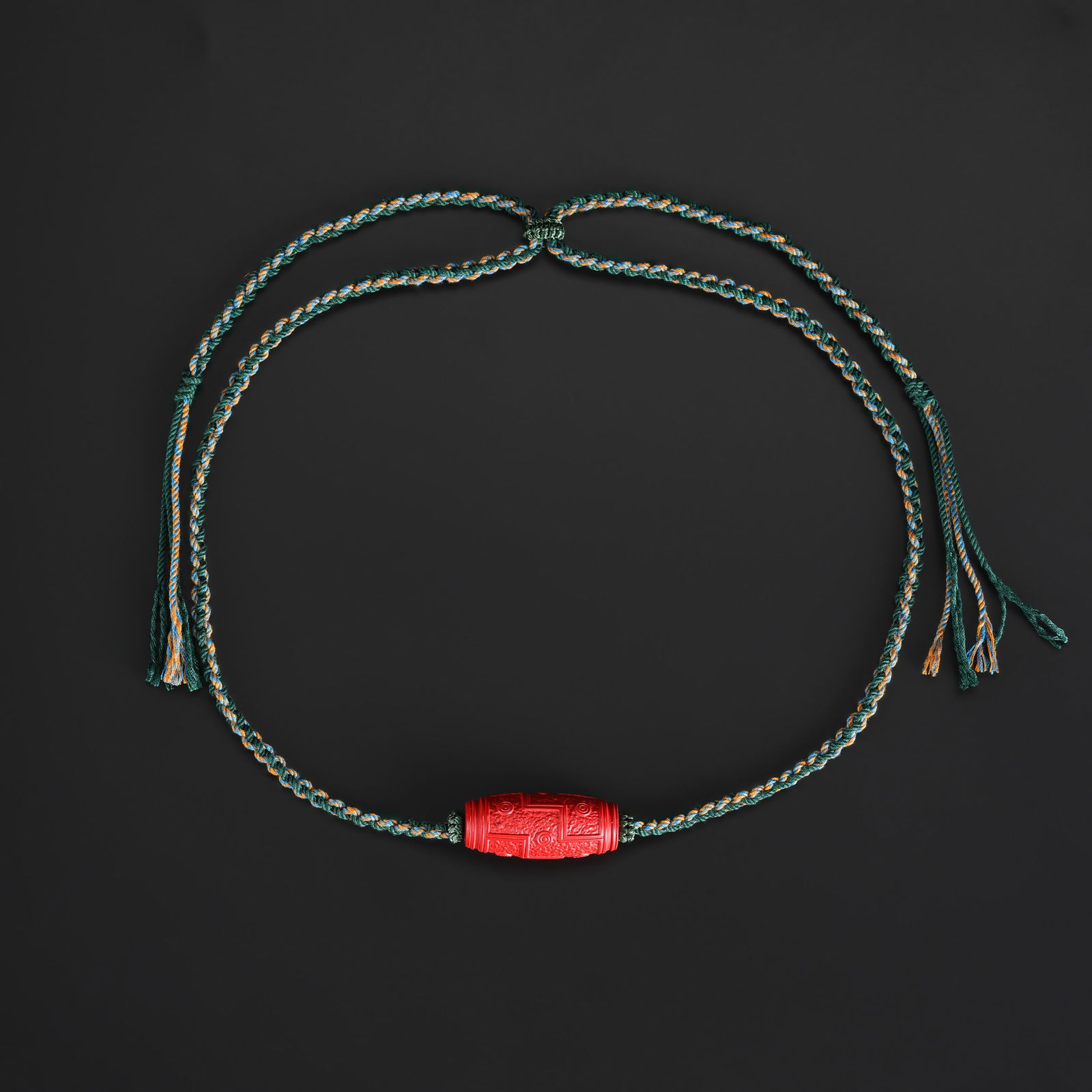 A Nine-Eye Cinnabar Bead Necklace with Handmade Knotted Design: A necklace featuring a cinnabar bead carved with a nine-eye motif, beautifully presented in a handmade knotted design. Total Weight: 24gram