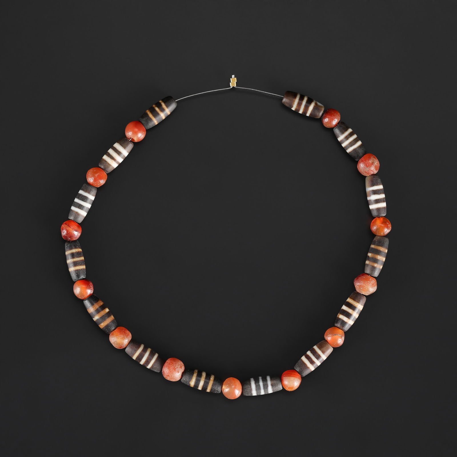 Chinese Tibetan Dzi Beads and Carnelain Beads Necklace: A collection comprising Tibetan Dzi beads and carnelian beads, displaying varied forms, patterns, and natural coloration, Length: 16in Total Weight: 50gram