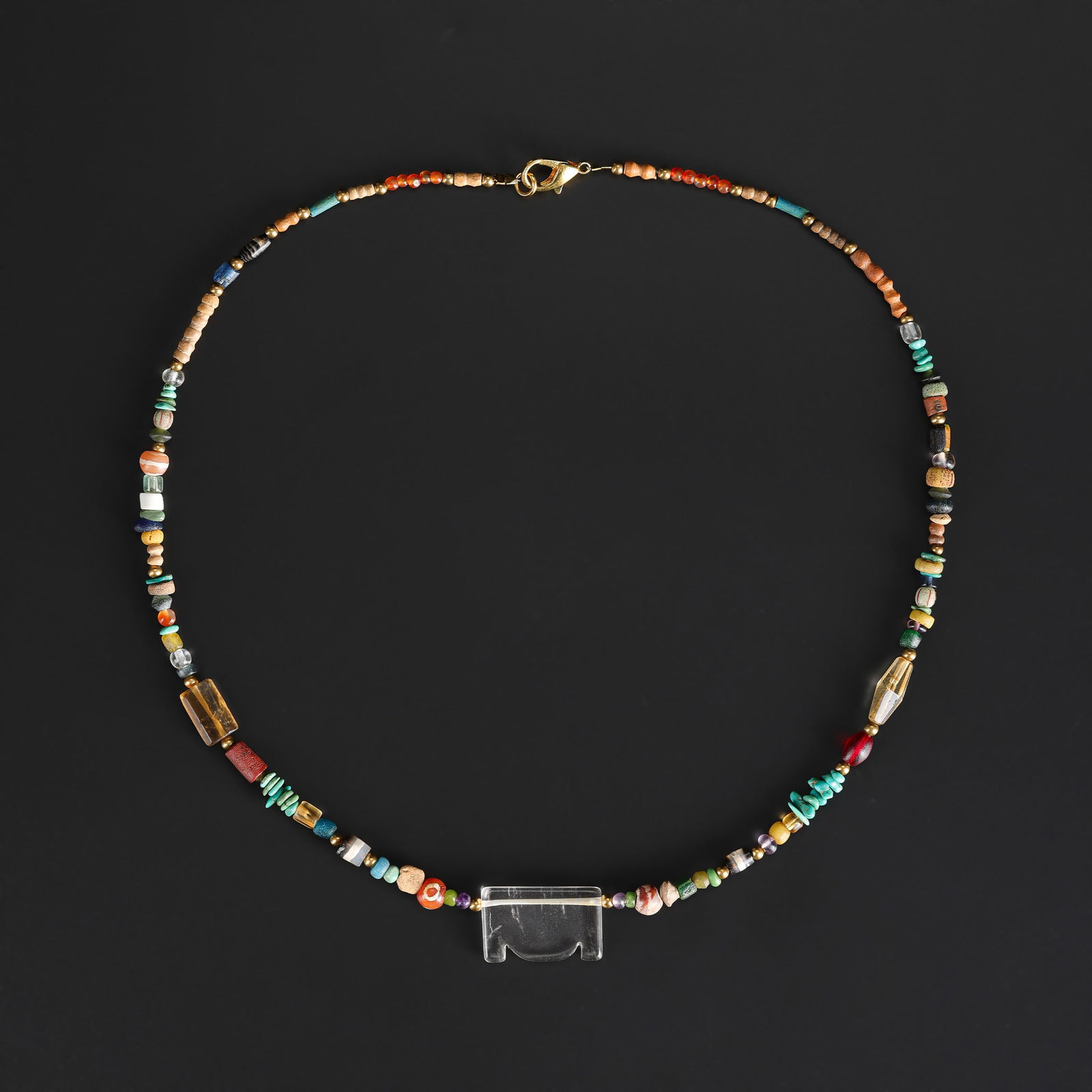 A Collection of Antique Mixed-Material Beads Necklace: A necklace comprising an assortment of antique beads in varied materials, shapes, and colors, showing natural wear and patina consistent with age. Length: 21in Total Weight: 18gram