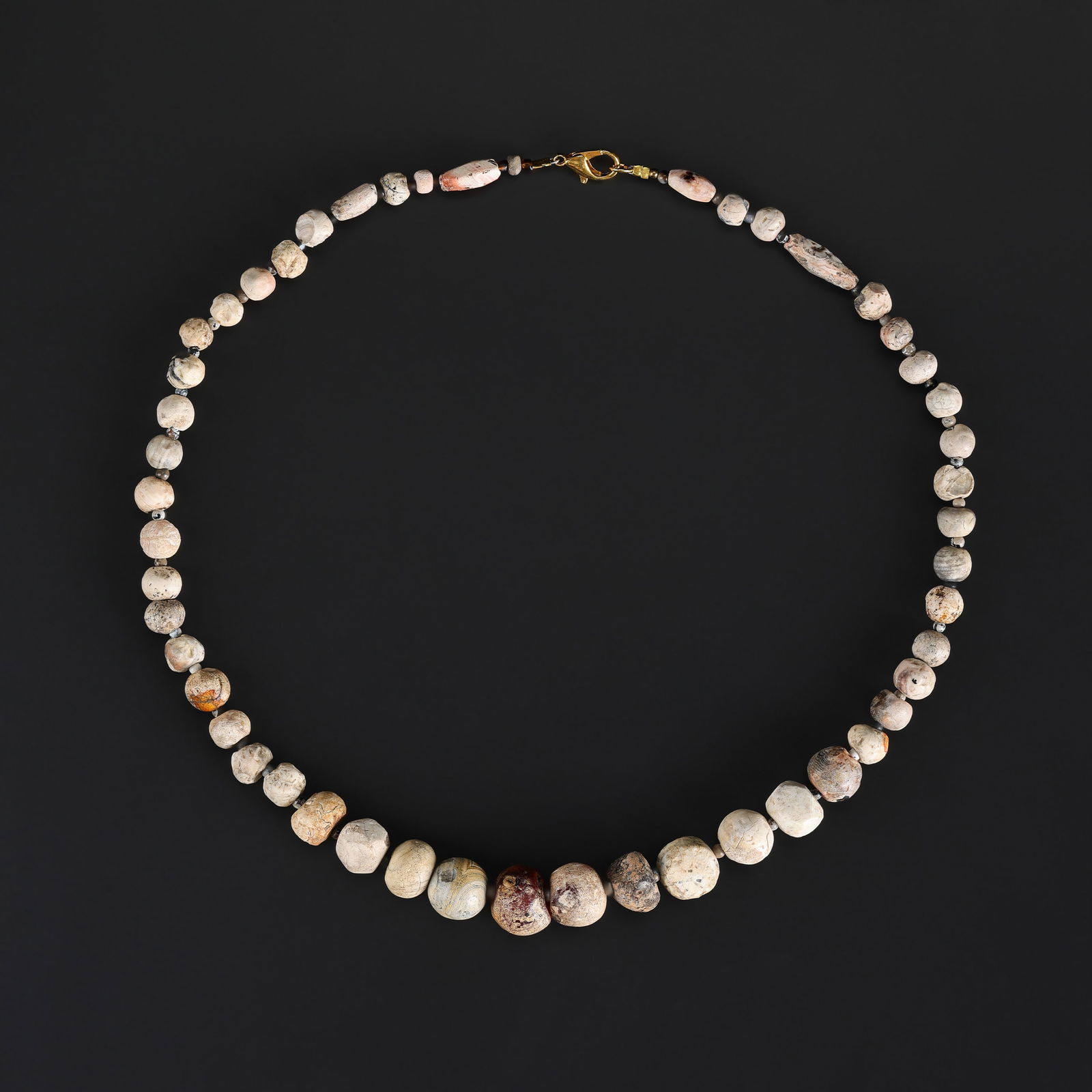 An Indo-Tibetan Ancient Agate Bead Necklace: A necklace composed of ancient agate beads from the Indo-Tibetan region, exhibiting natural color variations and age-appropriate patina. Length: 21in Total Weight: 64gram