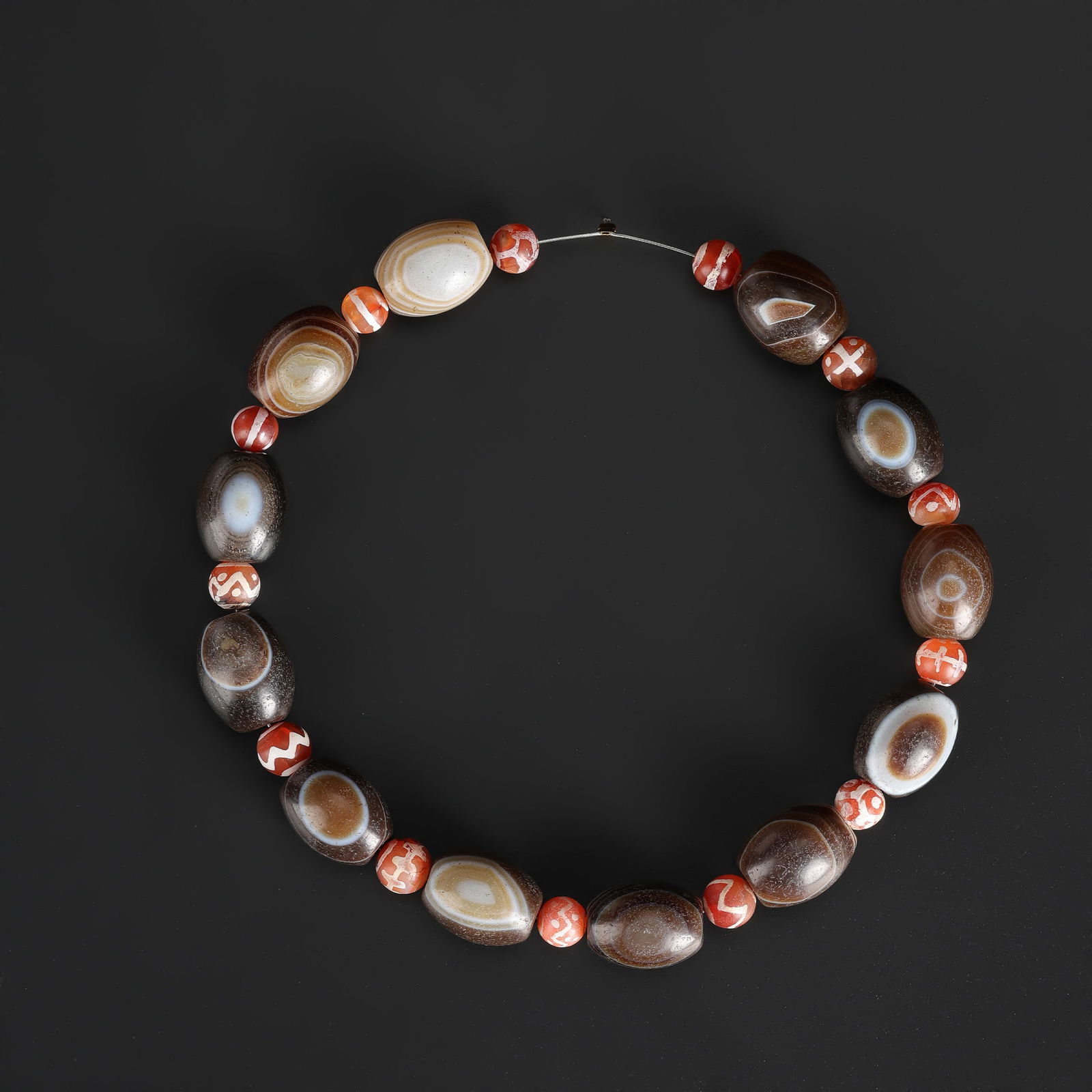 A Lot of Indo-Tibetan Banded Agate Beads with Natural Eye Patterns and Etched Carnelian Beads: A collection of Indo-Tibetan beads, including banded agate with natural eye patterns and etched carnelian beads. Length: 14in Total Weight: 86gram