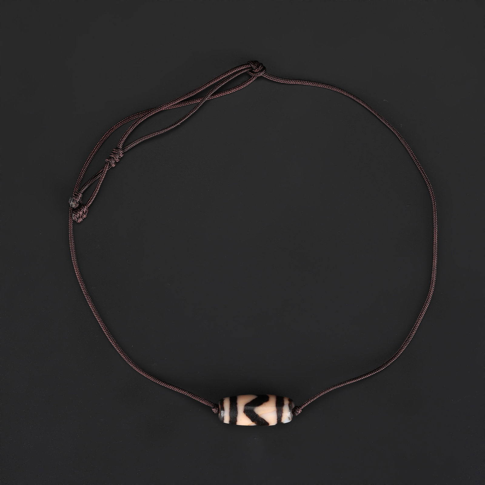 Tibetan Tiger Teeth-Pattern Dzi Agate Bead Necklace, Hand-Knotted: A Tibetan Dzi agate bead necklace featuring tiger teeth-pattern motifs, carefully hand-knotted on soft fabric cord to form a wearable and elegant design. Total Weight: 8gram