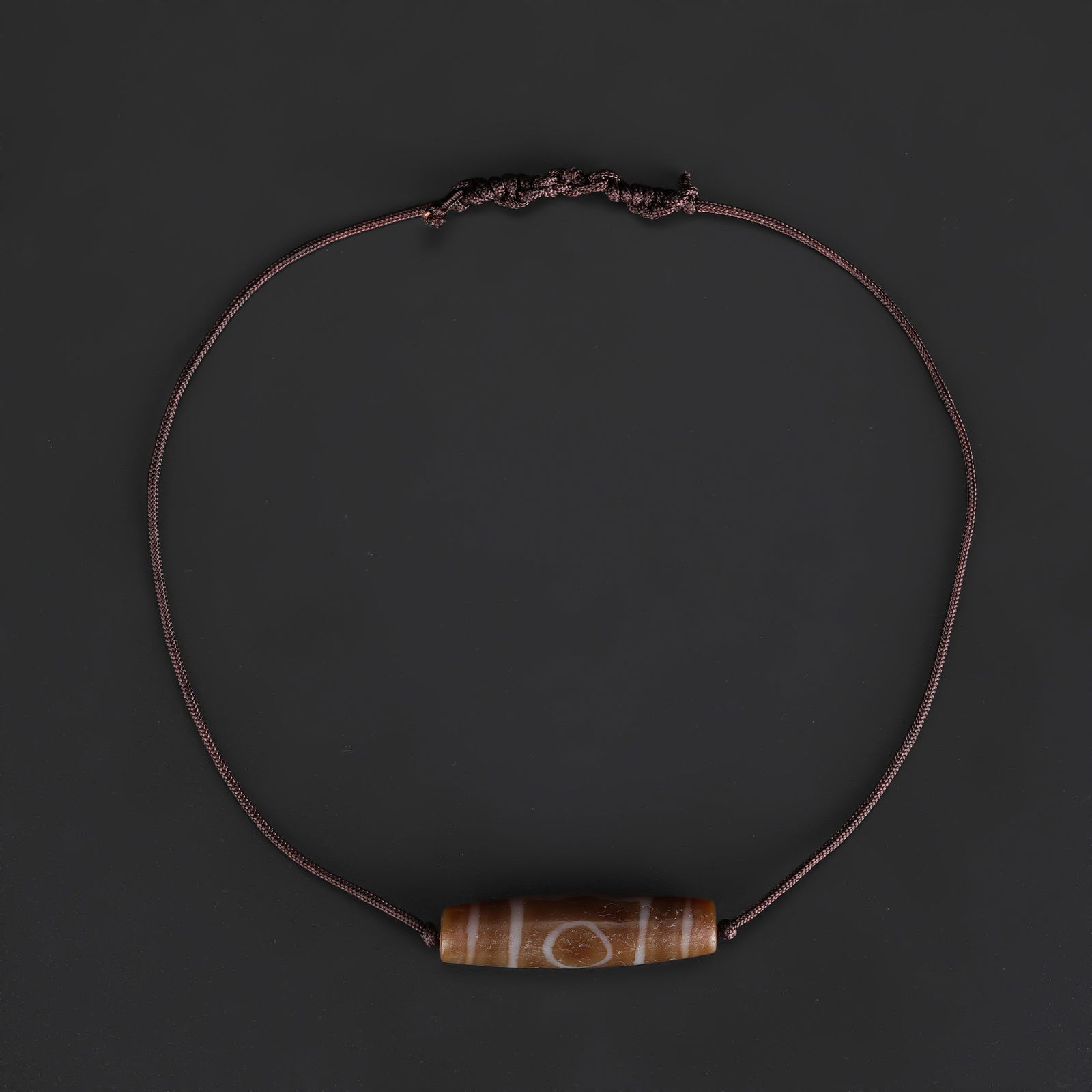 Tibetan 3-Eye Dzi Agate Bead Necklace, Hand-Knotted: A Tibetan Dzi agate bead necklace featuring 3-eye motifs, skillfully hand-knotted on soft fabric cord to create a wearable design. Total Weight: 10gram