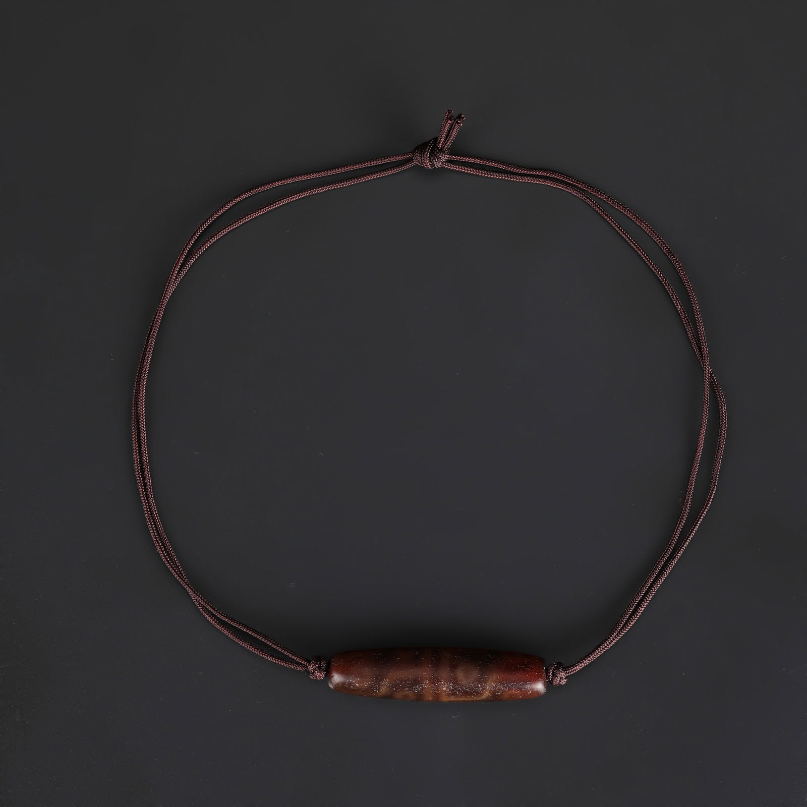 Tibetan 12-Eye Dzi Agate Bead: A Tibetan Dzi agate bead necklace featuring 12-eye motifs. Total Weight: 15gram