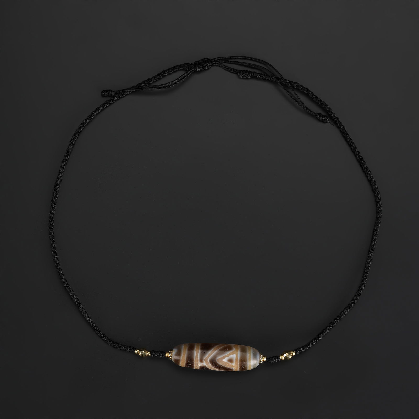 Tibetan Phum Dzi Necklace Featuring a Rare Pattern Bead: Tibetan Phum Dzi bead featuring a rare and distinctive pattern, strung as a necklace and hand-knotted using soft fabric cord. Total Weight: 15gram
