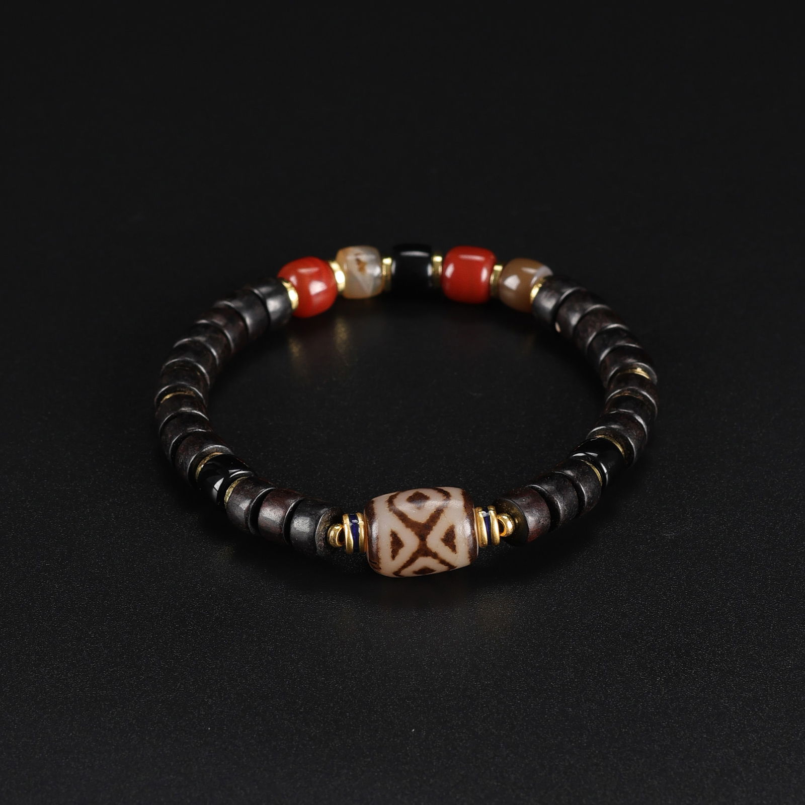 Tibetan Bracelet Featuring Rare-Pattern Dzi Bead with Complementary Beads: Tibetan bracelet showcasing a rare-pattern Dzi bead as its centerpiece, strung alongside carefully selected complementary beads. Total Weight: 14gram
