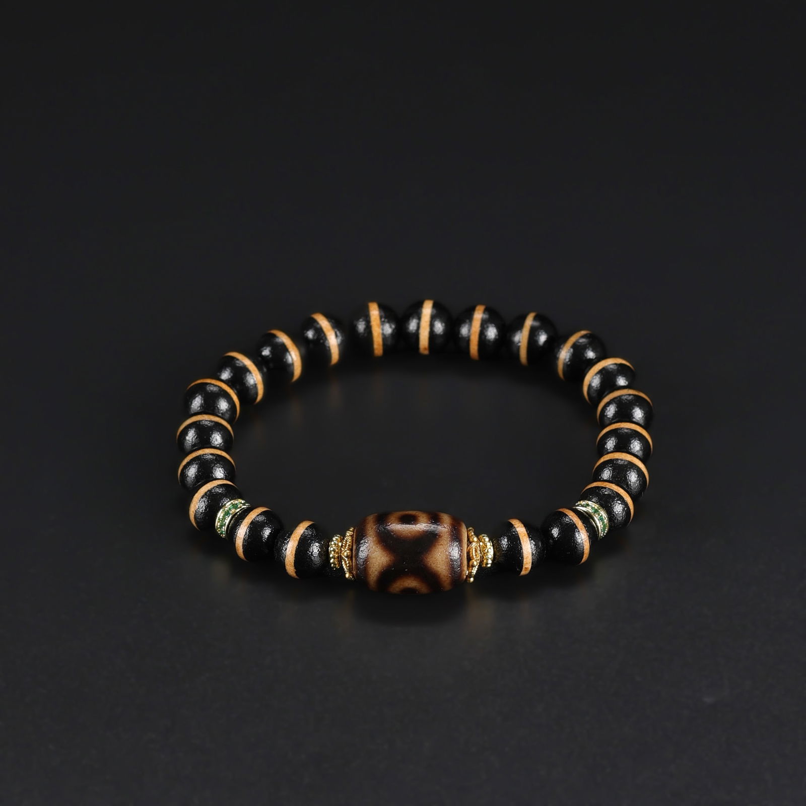 Tibetan Bracelet Featuring Three-Eye Dzi Bead with Single-Line Dzi Accents: Tibetan bracelet featuring a prominent Three-Eye Dzi bead paired with single-line Dzi beads, expertly strung to create a balanced and visually striking design. Total Weight: 20gram