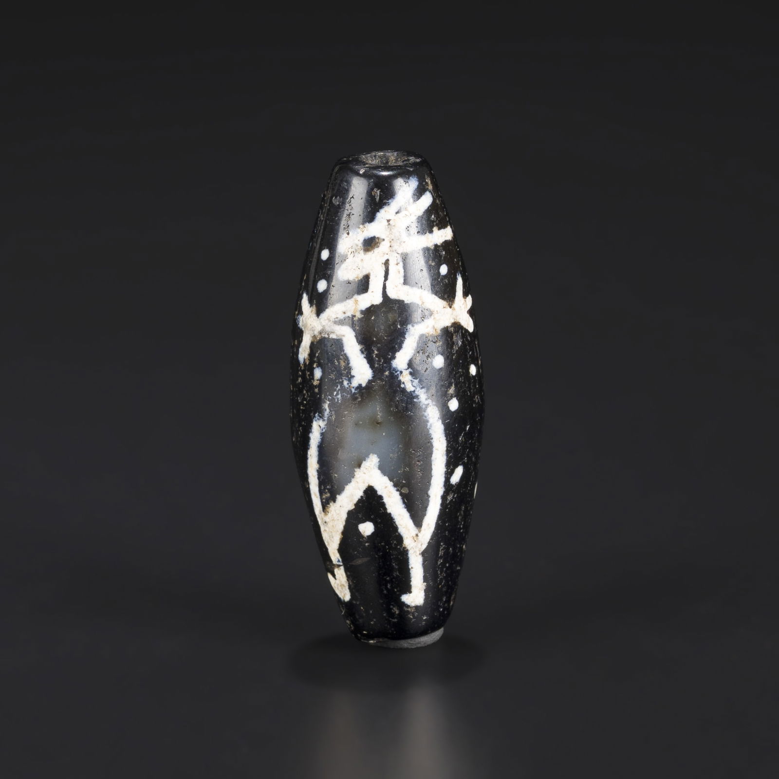 Tibetan Agate Dzi Bead with Mythical Motif: Tibetan Agate Dzi Bead with Mythical Motif Size Detail: 1.5 x 3.9cm Weight: 13gram