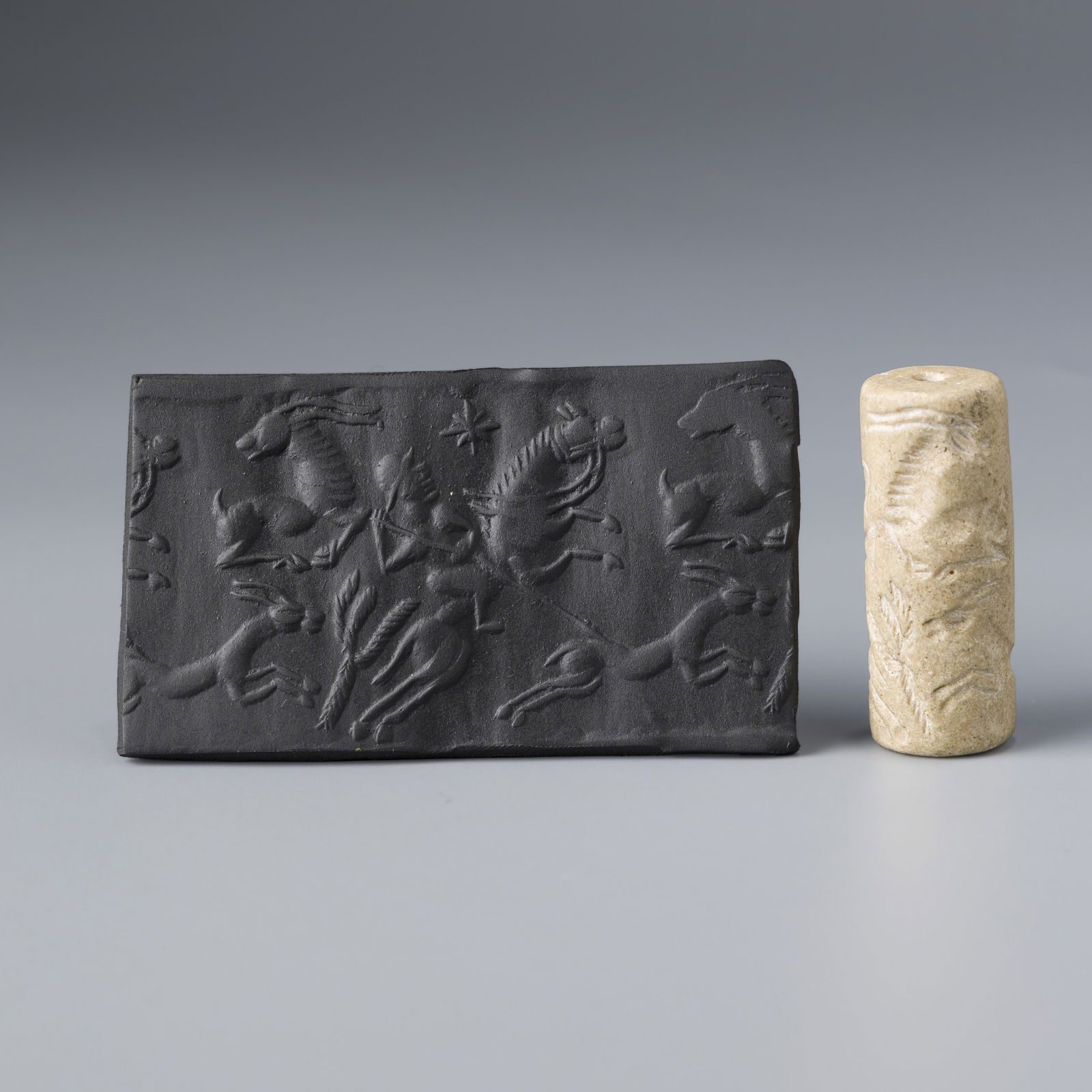 Near Eastern Sasanian White Jasper Stone Cylinder Seal Pendant: A Near Eastern Sasanian white Jasper stone type material cylinder seal pendant featuring detailed engraved designs and figures.Photos include impressions made on wax clay to clearly display the carved
