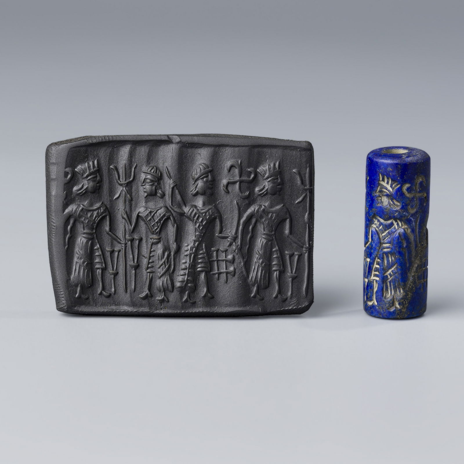 Ancient Near Eastern Achaemenid Lapis Lazuli Cylinder Seal Bead: An Ancient Near Eastern Achaemenid bead pendant crafted from lapis lazuli, intricately depicting figures. For a clearer view of the stamped design, impressions made on wax clay are included in the pho