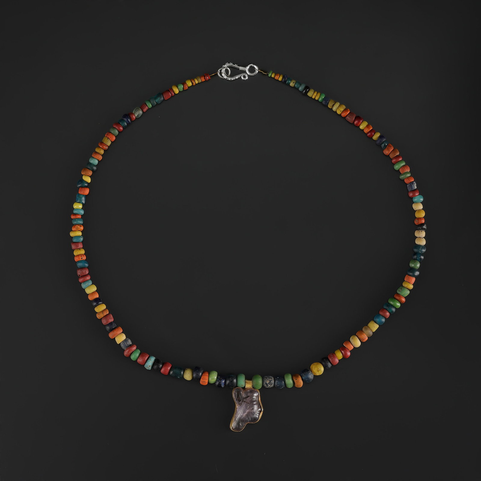 Mixed Antique Glass Beads with Egyptian 18K Gold Pendant: Fine Gold Mixed Antique Glass Beads with Egyptian 18K Gold Pendant. A desirable auction piece with strong decorative presence and fine gold craftsmanship. Well suited for ethnographic jewelry collecto