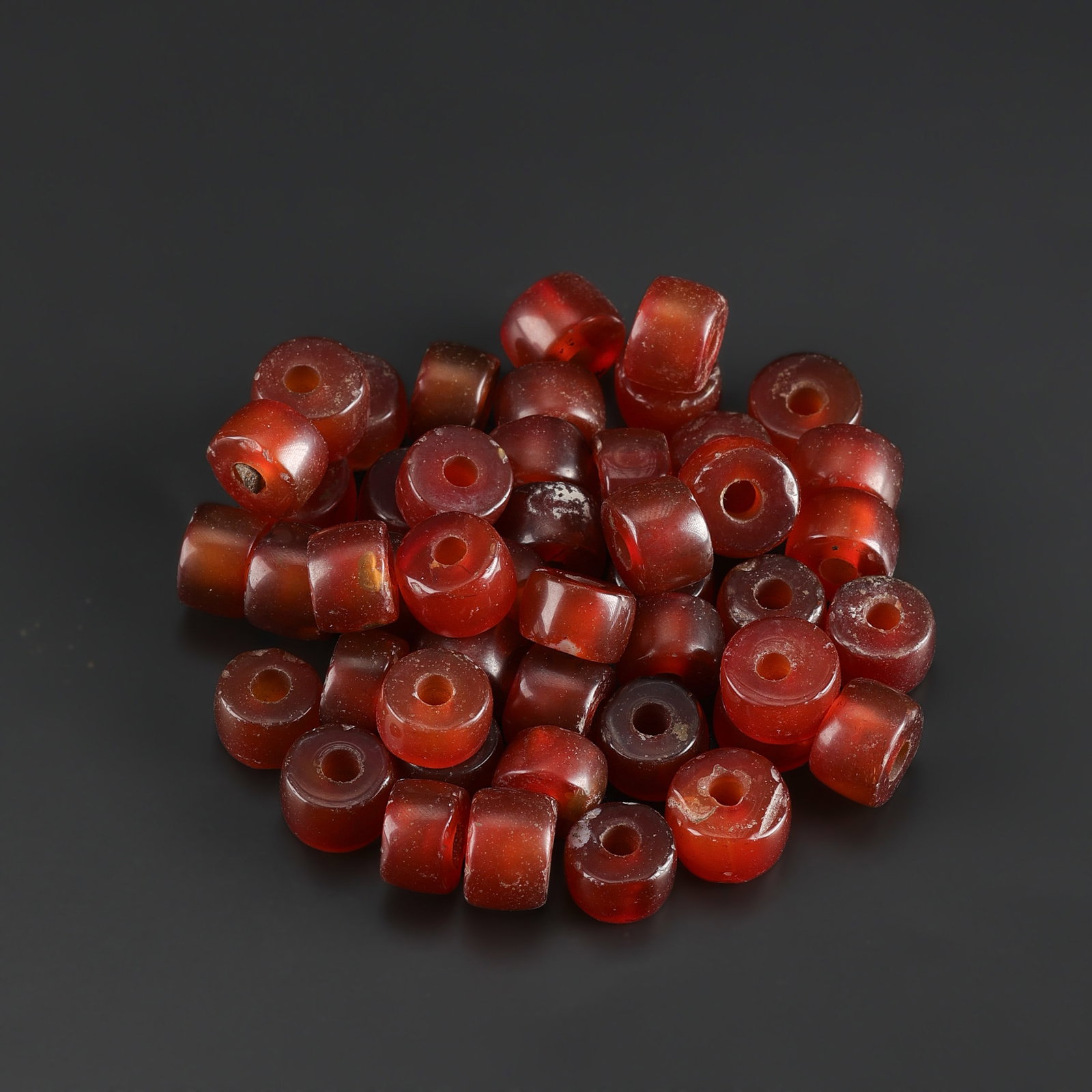 Liao Dynasty Carnelian Agate Beads Lot: Fine Bead Group Liao Dynasty Carnelian Agate Beads Lot. A desirable auction piece showing attractive natural color, texture, and character. Well suited for ethnographic jewelry collectors, display, or