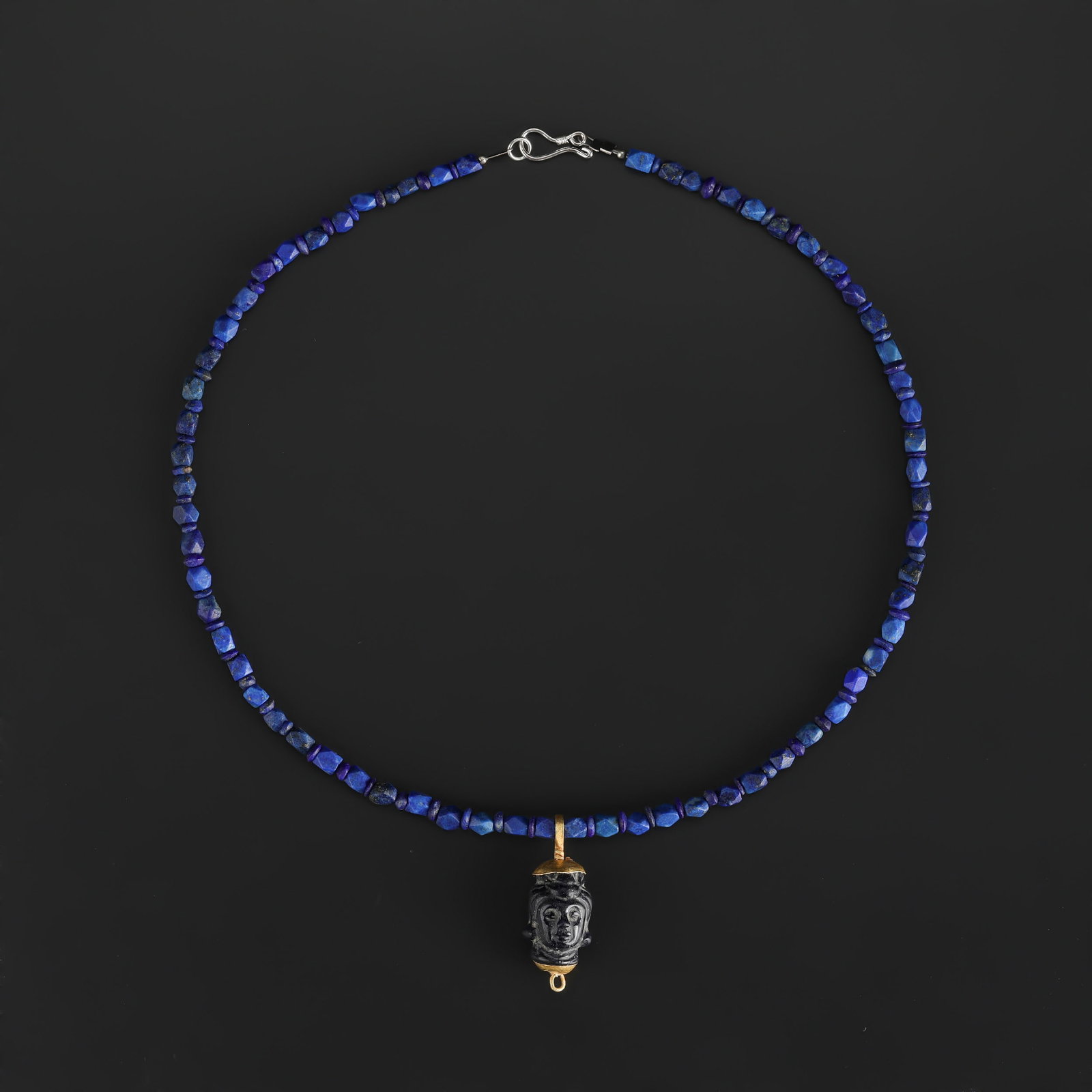 Fine Lapis Lazuli Necklace with Carved Face with 18K Gold Mount Pendant: Fine Lapis Lazuli Necklace with Carved Face with 18K Gold Mount Pendant, featuring selected beads or ornaments with decorative appeal for collectors. Length: 18in Total Weight: 16gram