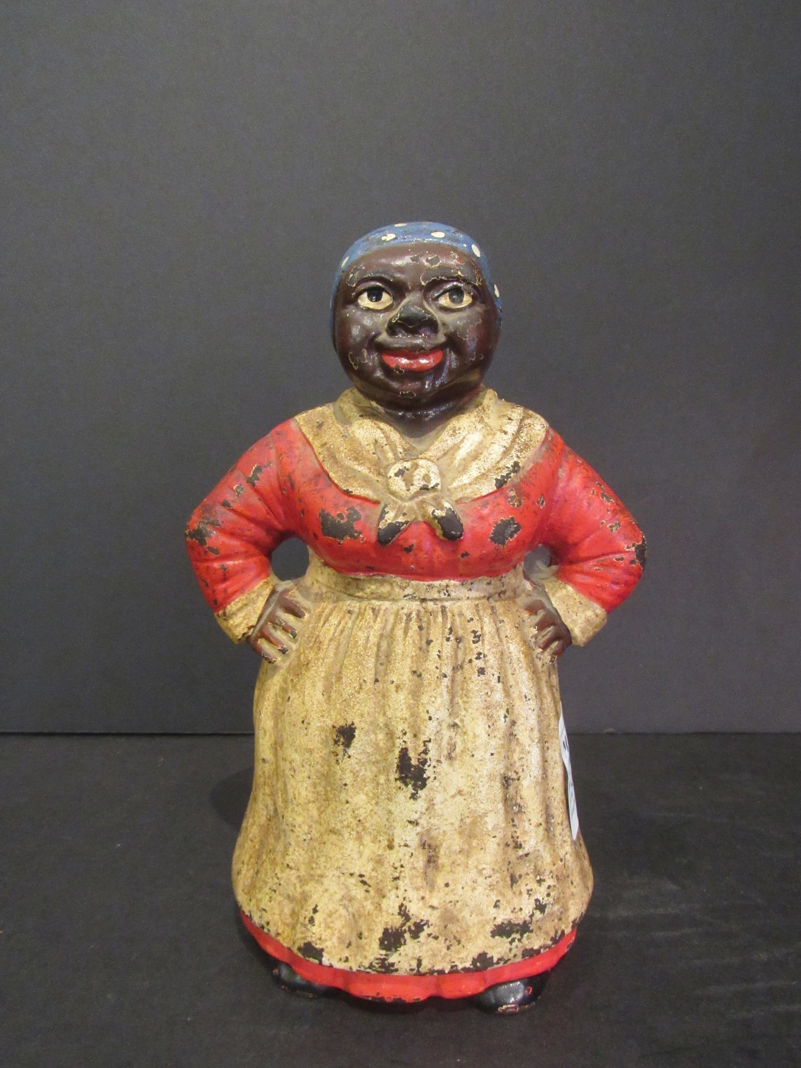 Antique Cast Iron Aunt Jemima Door Stop Black Americana: Antique Cast Iron Aunt Jemima Door Stop Black Americana. She is wearing a blue hankerchief with white polka dots, red dress, black shoes, white scarf and apron.