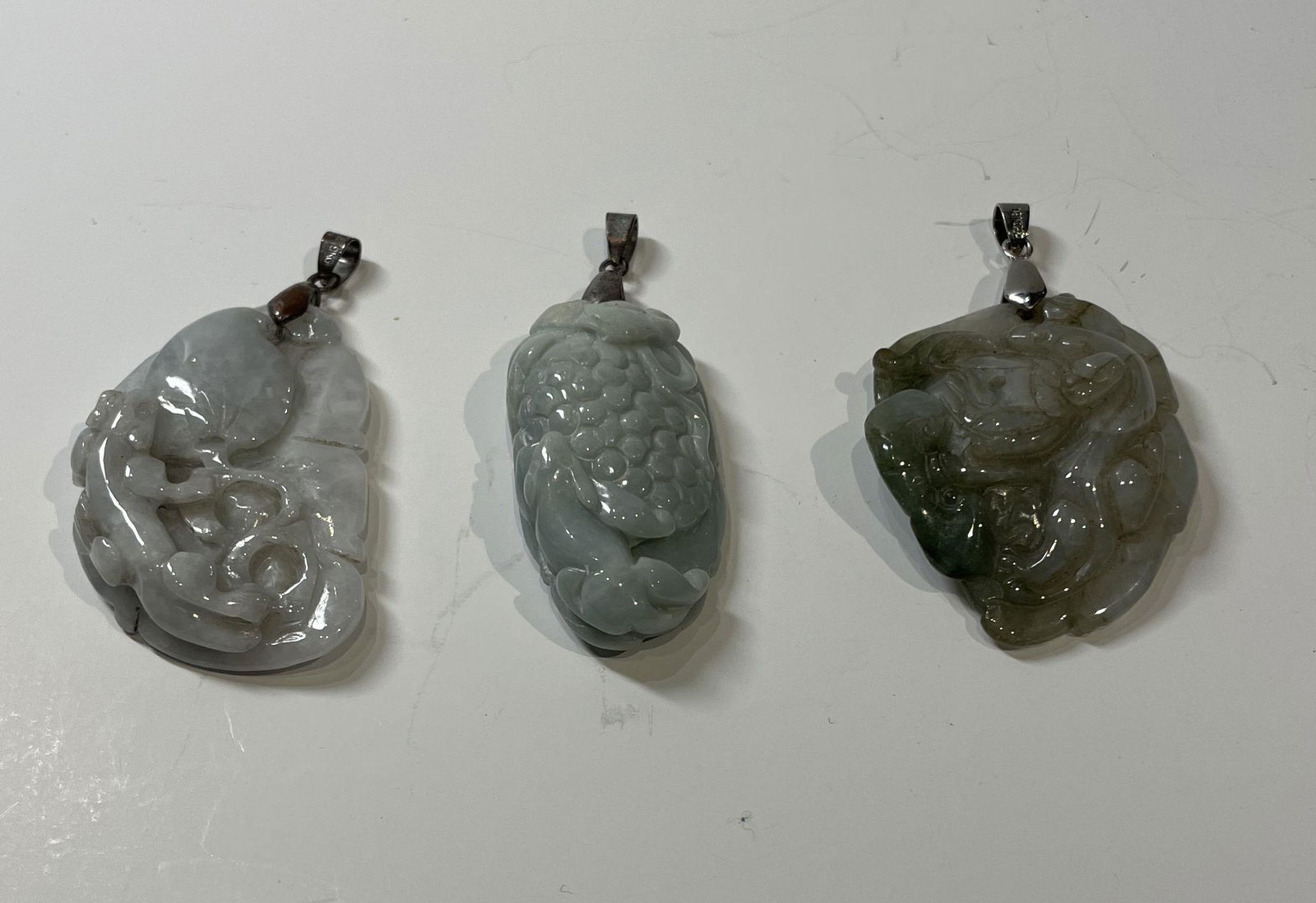 Lot of three Chinese carved jade jadeite pendants (1 of 4)