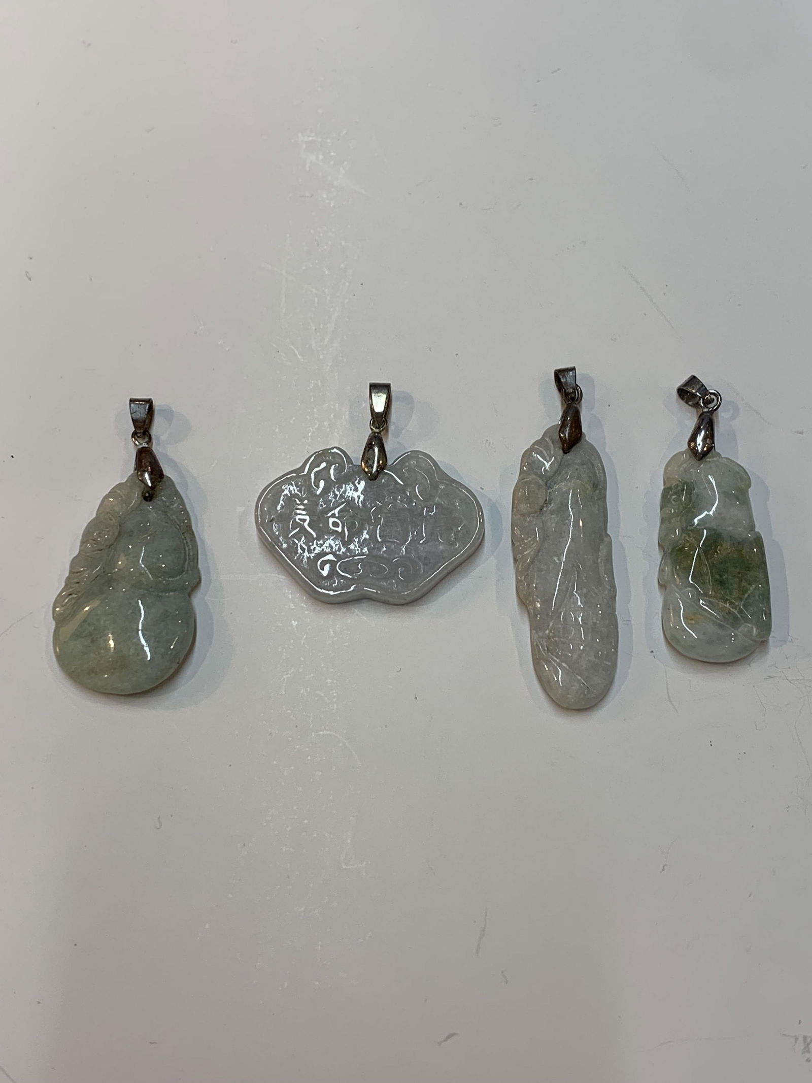 Lot of four Chinese carved jade jadeite pendants (1 of 2)