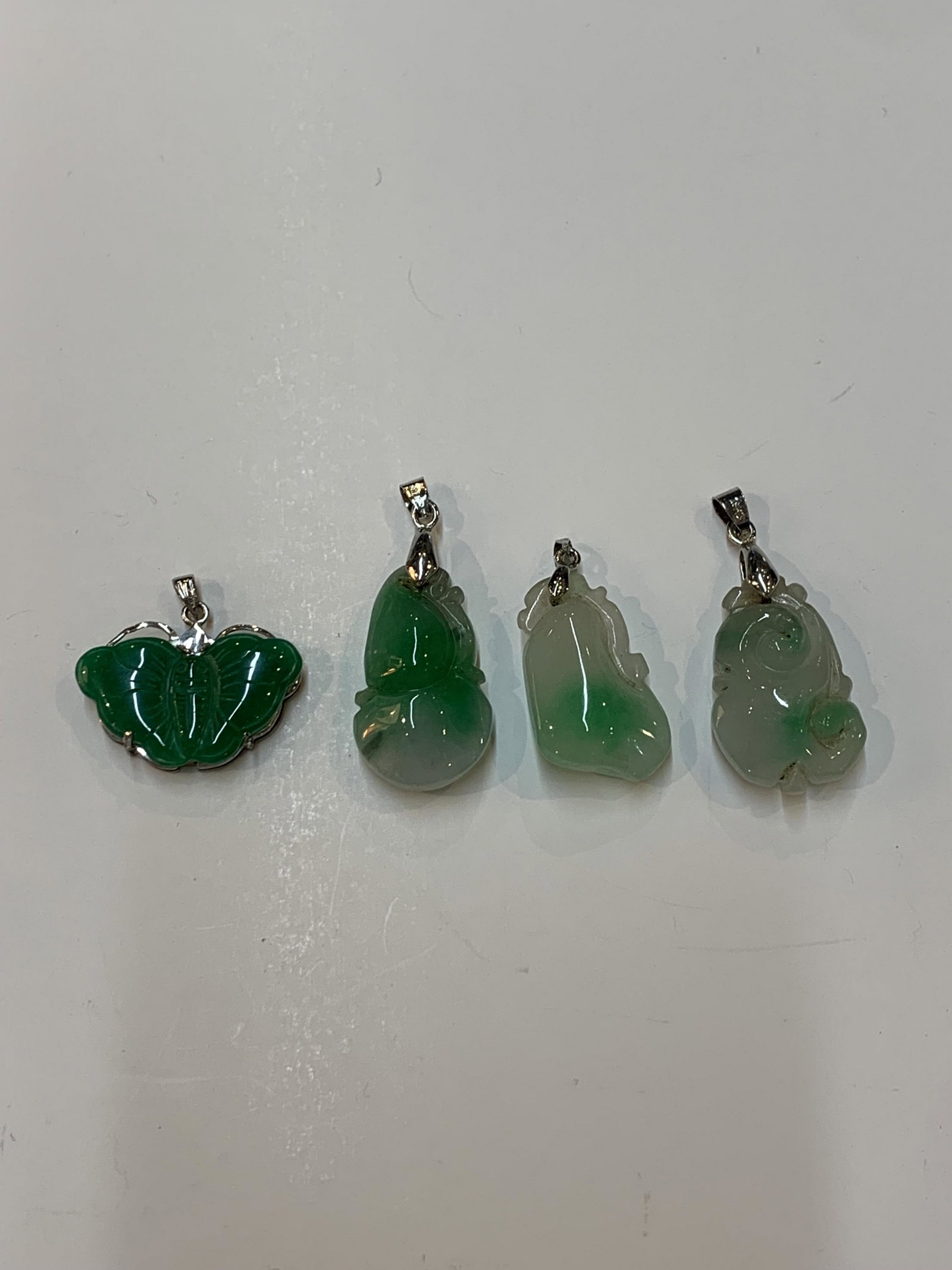 Lot of four Chinese carved Jade Jadeite pendants (1 of 3)