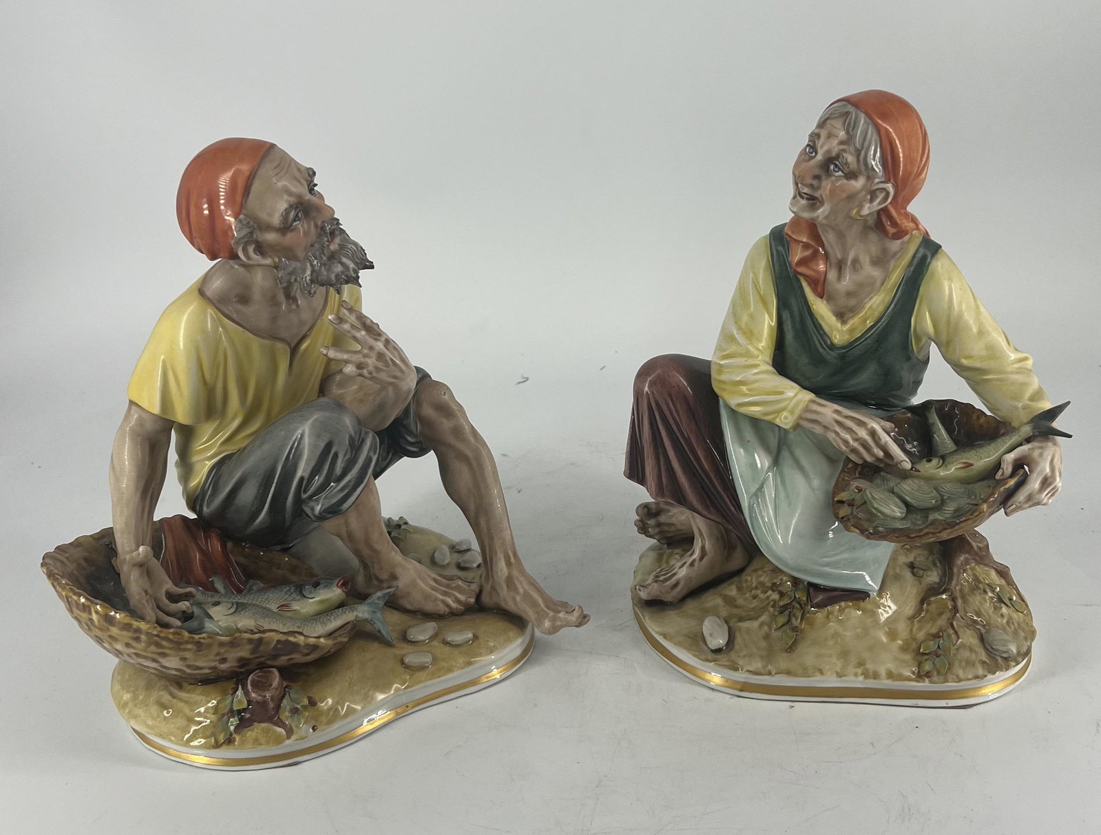 Antique Pair of Capodimonte Dresden Porcelain Fishermen Figurines: Antique Pair of Capodimonte Dresden Porcelain Fishermen w/ Fish Figurines. There is a faded mark on the bottom.