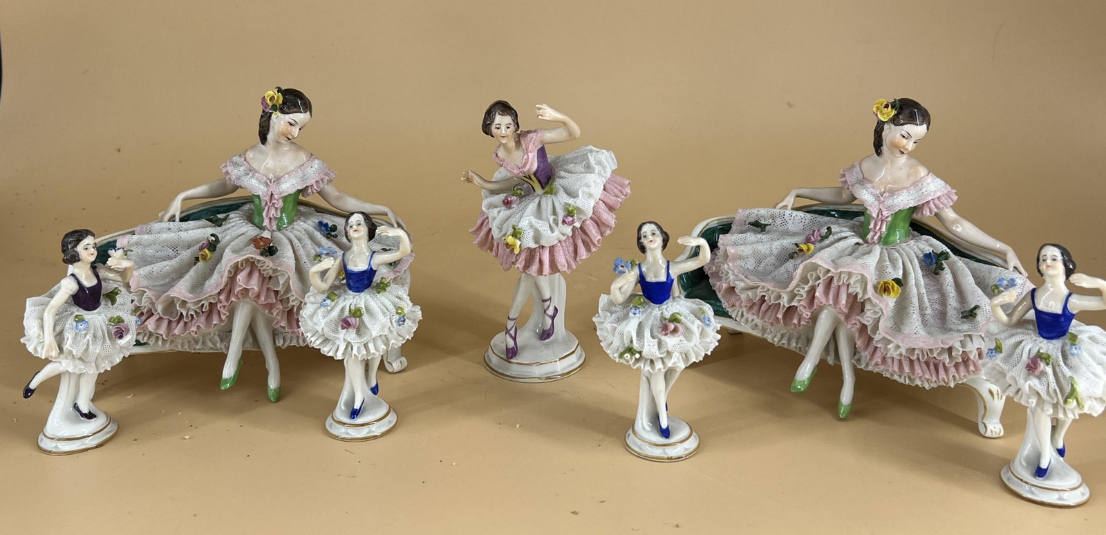 Vintage Lot of 7 Dresden Germany Porcelain Lace Figurines: Vintage Lot of 7 Dresden Germany Porcelain Lace Figurines. Includes 2 woman seated (5.5" x 7"), one large woman dancing (5.75" x 3.5"), and 4 small woman dancing (4" x 2.25"). All of the figurines hav