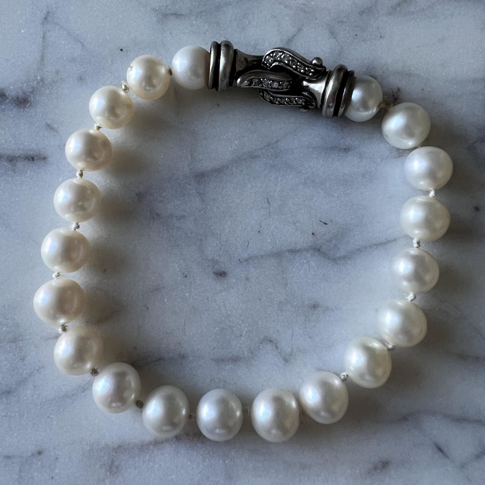 Vintage David Yurman Genuine Pearl Bracelet w/ Sterling Silver Diamond Clasp: Vintage David Yurman genuine pearl (8.28mm) bracelet with a sterling silver diamond clasp. Approximate length measures at 8", and weighs at 23g.