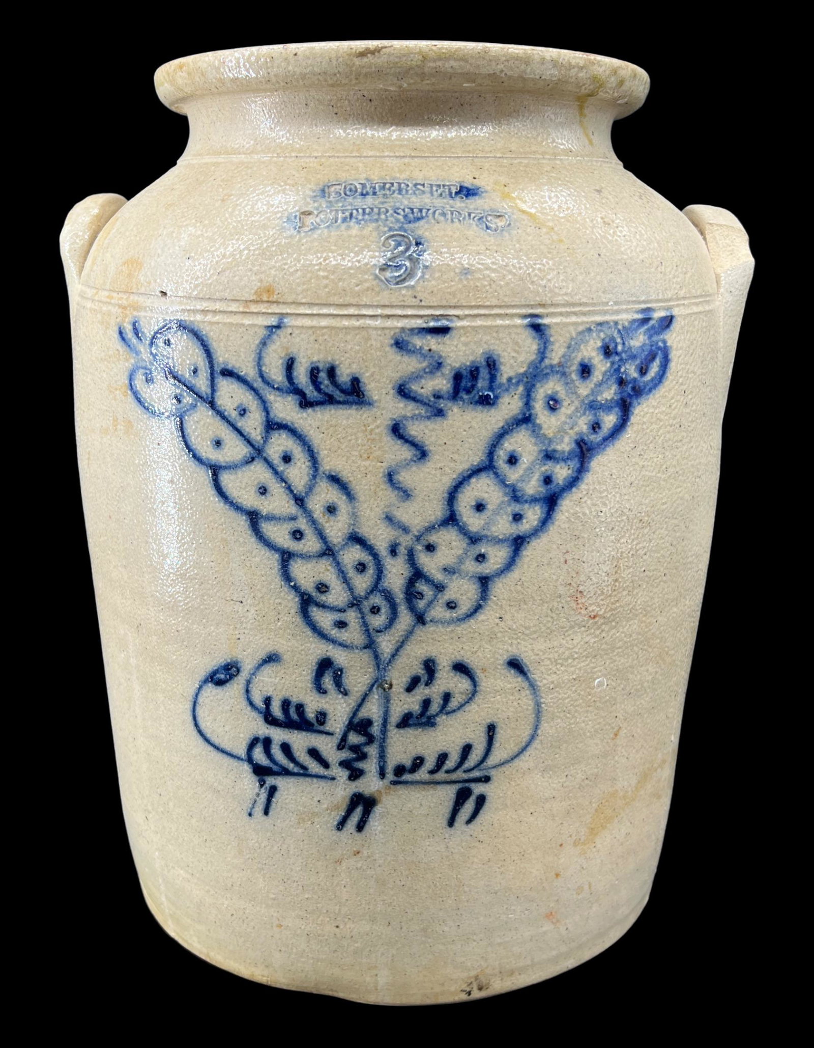 Antique Primitive 3-Gallon Stoneware Jug with Handles & Floral Decoration: Antique primitive 3-gallon stoneware jug with elephant ear handles and cobalt blue floral design. The jug is signed "Somerset Potters Works". Size: 13.5" x 11". Design is a grain or wheat.