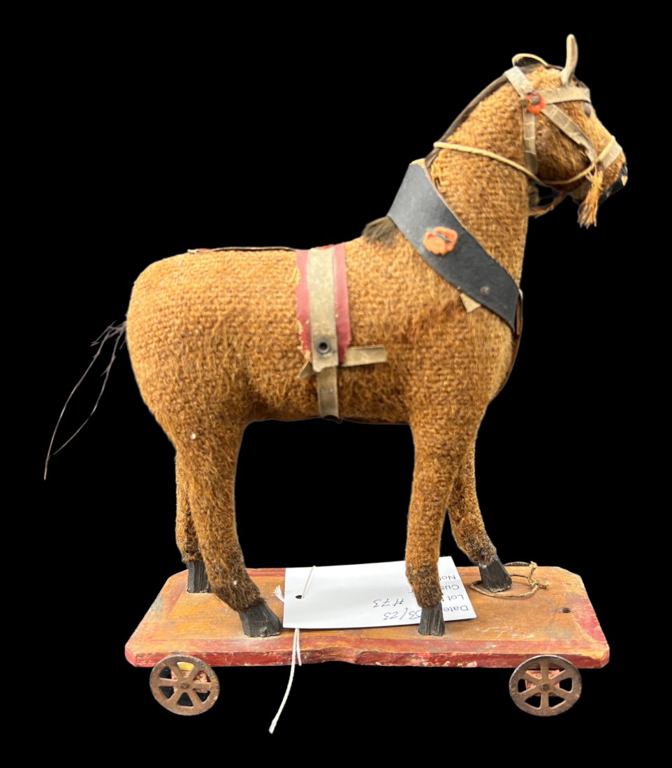 Antique Primitive Horse Equestrian Children's Pull Toy: Antique primitive children's toy. Material fabric horse on a wooden base with tin wheels. 19th century children's pull toy, original string missing. Missing the tail. Size : 10" x 7.25". Folk art.