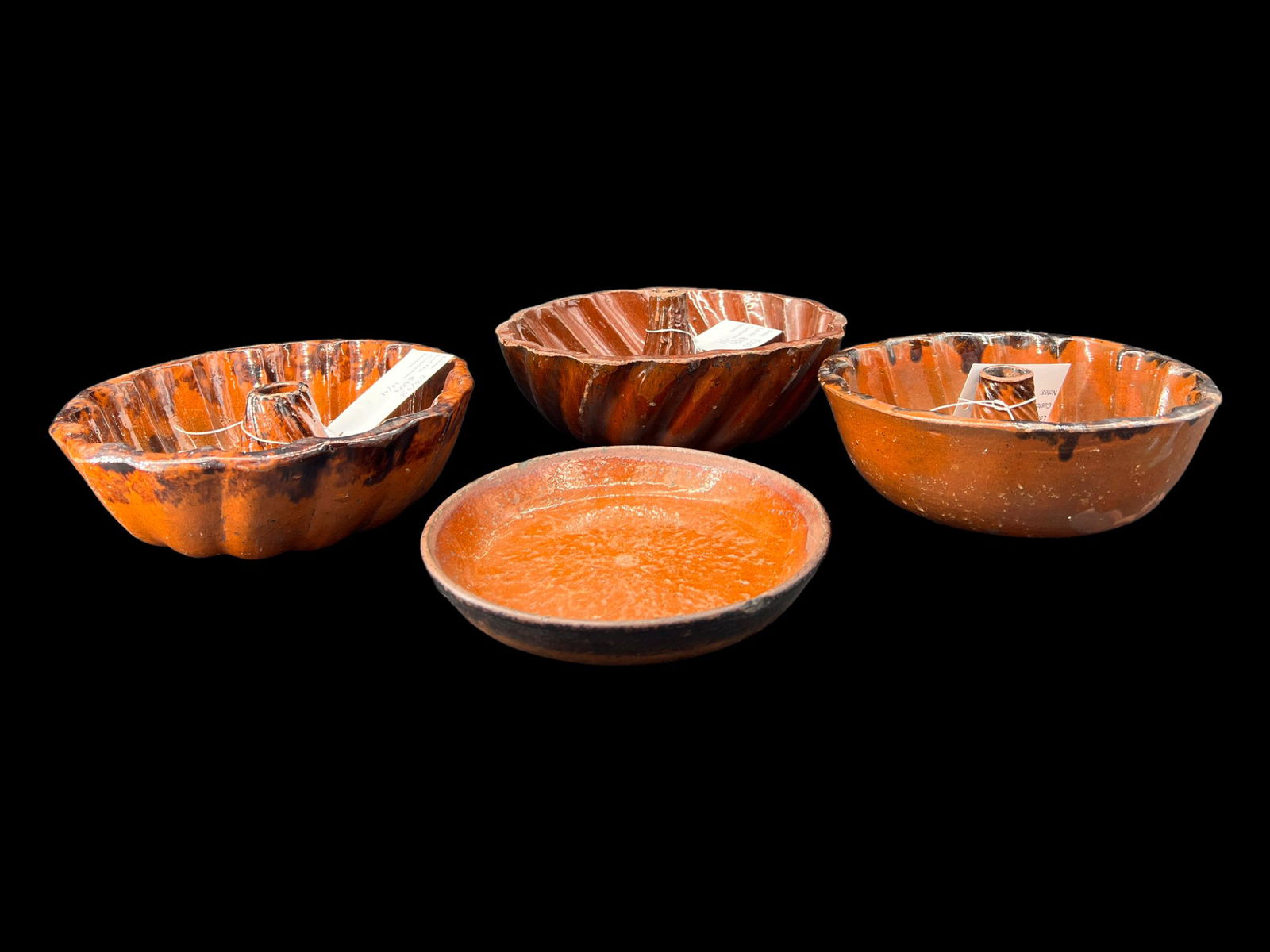 Lot of 4 Antique Redware Bundt Cake Molds: Antique lot of 4 redware bundt cake molds. This lot includes 3 redware bundt cake molds and one redware dish. No chips or cracks. Size: 9" x 3.5". Folk art.