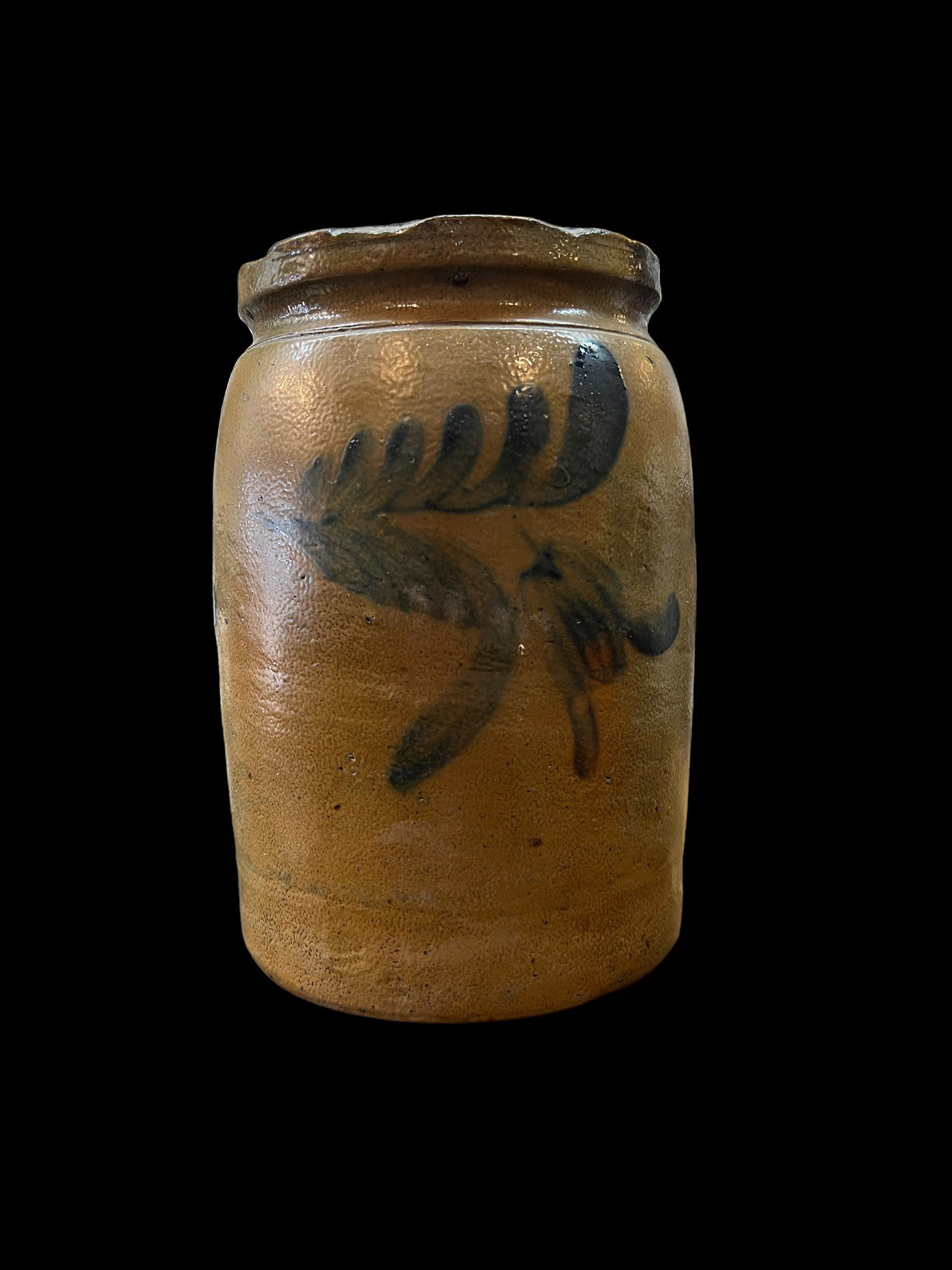 Antique Primitive Stoneware Pottery Crock Cobalt Blue Floral: Antique primitive stoneware crock with rounded rim and cobalt blue floral decoration. This piece is not signed. Size: 8.5" x 5.5".