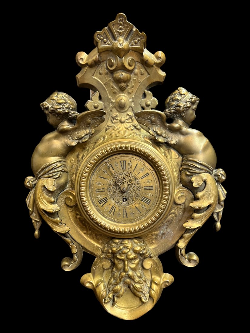 Antique Ornate Gilt Bronze Cherub Putti Clock: Antique Gilt Bronze Cherub Putti Clock. Working. Size: 18.5" x 24.5" x 6.75".2 cherubs on the sides and the North Wind / Green Man on the bottom.