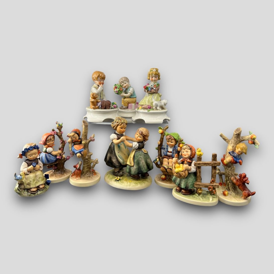 Antique Lot of 10 Hummel Porcelain Figurines: Antique Lot of 10 Hummel Figurines. #256 By A Garden Pond, #245 Country Lad, #257 Girl With Kittens, Apple Tree Girl, Apple Tree Boy, Out of Danger, Culprits, #385 Chickin Lickin, #353/0 Spring Dance,