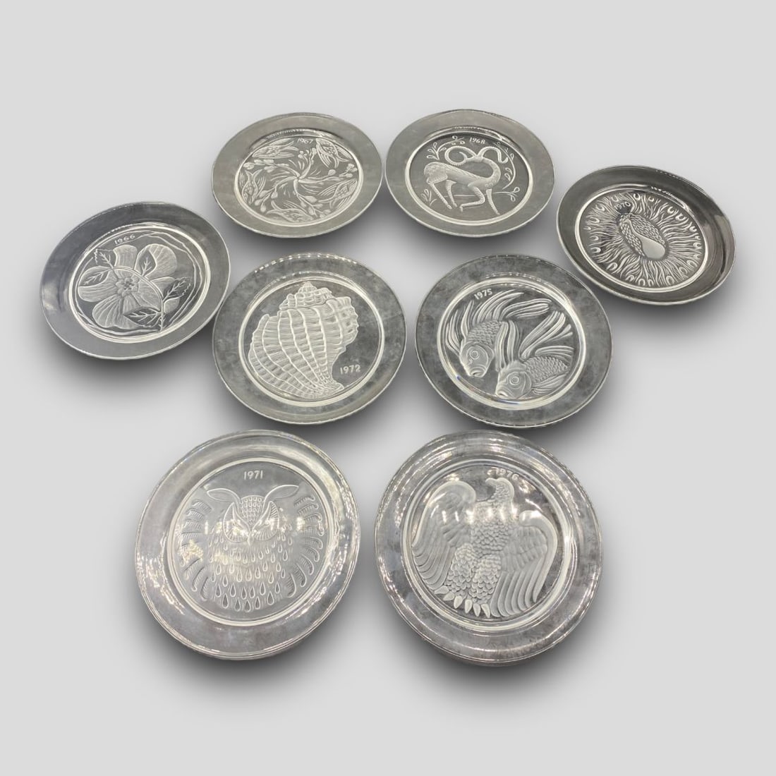 Vintage Lot of 8 Lalique France Crystal Annual Plates: Vintage Lot of 8 Lalique France Crystal Annual Plates. Includes 1966, 1967, 1968, 1970, 1971, 1972, 1975, 1976. Signed.