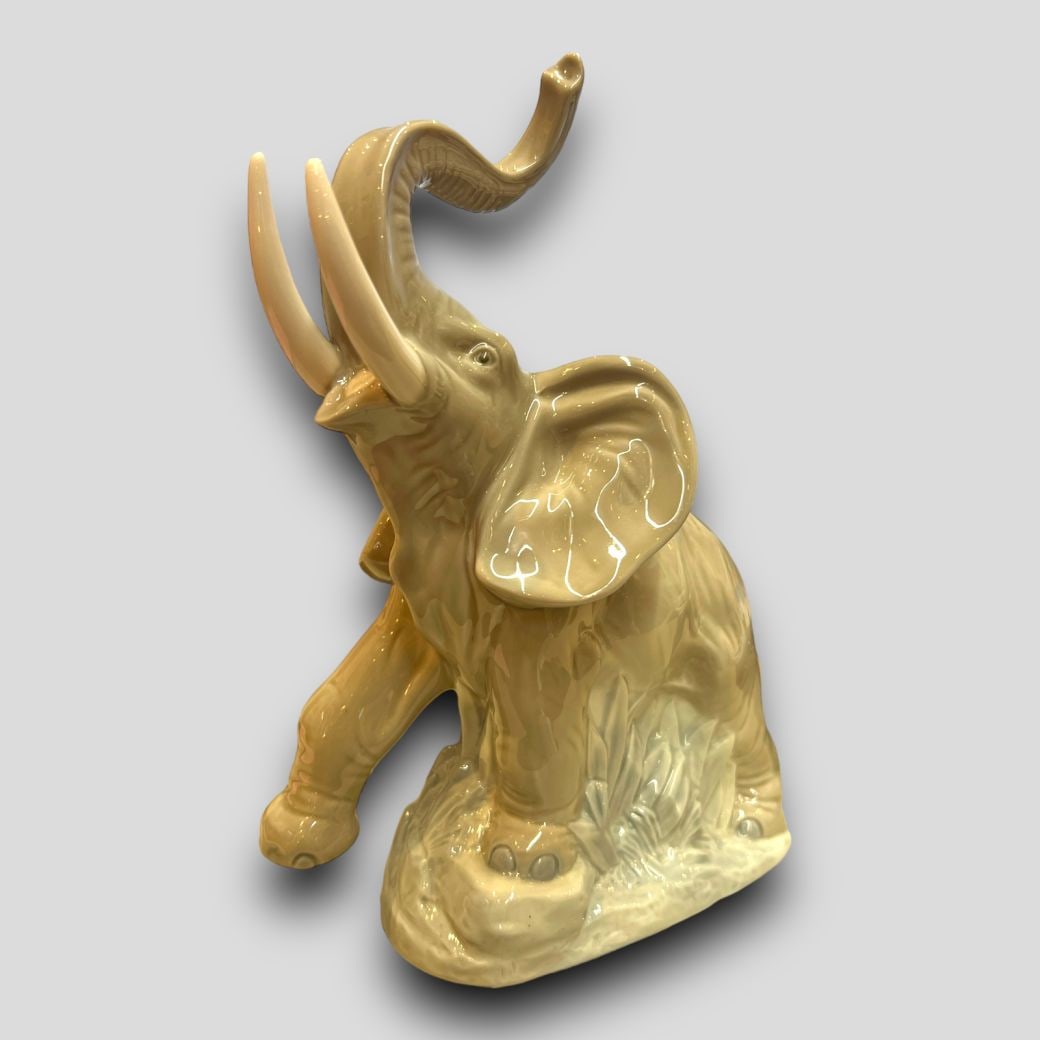 Antique Lladro Spain Nao Trunk Up Elephant Porcelain Figurine: Antique Lladro Spain Nao Trunk Up Elephant Porcelain Figurine. Signed on the bottom. Trunk up elephant for good luck. No chips or cracks. Approximate size: 8.75'' x 6'' x 6''
