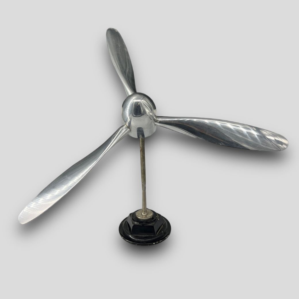 Vintage Modernist Stainless Steel Propellor Statue Sculpture on Stand: Vintage Modernist Stainless Steel Propellor Statue Sculpture on Stand. Possibly a real propellor from plane. Either stainless steel or aluminum. Mounted on stand. Approximate size: 22.25'' x 15'' x 15