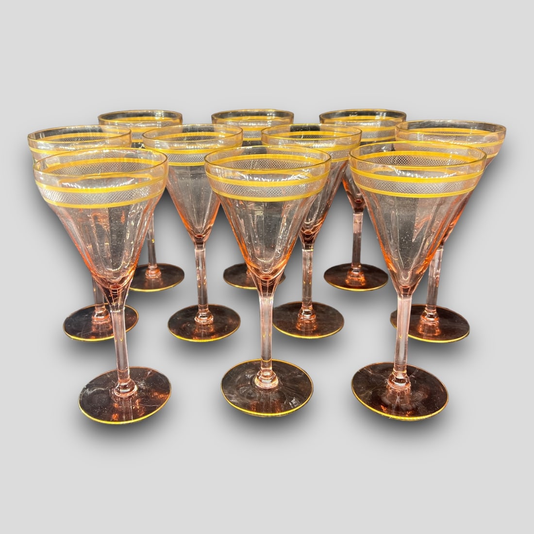 Vintage Lot of 10 Pink Peach Depression Glass Glasses: Vintage Lot of 10 Pink Peach Depression Wine or Water Glass Goblets. Unsigned. Gold plated on the rims. Size: 7 7/8".
