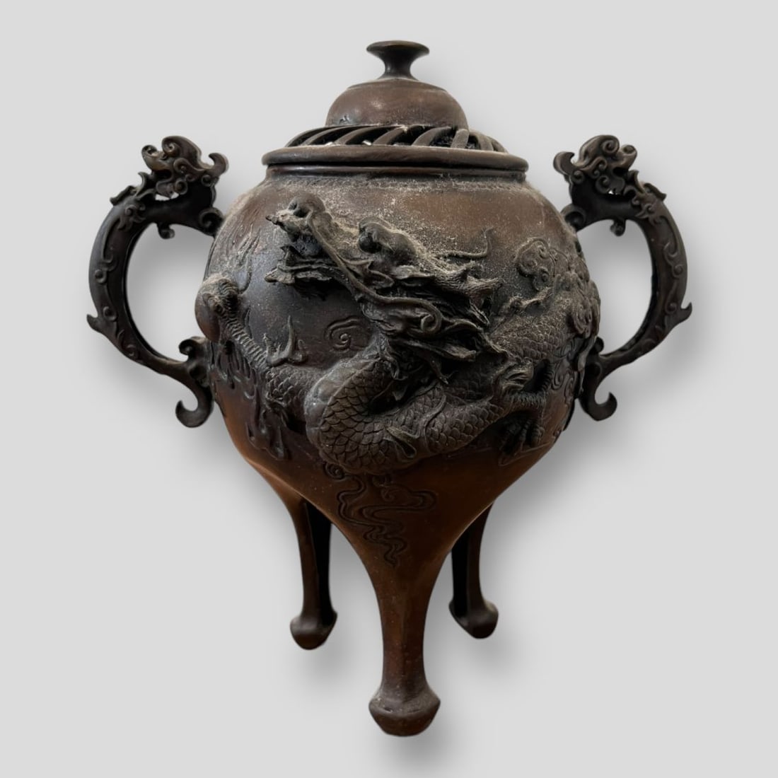 Antique Japanese Dragon Bronze Incense Burner: Antique Japanese Dragon Bronze Incense Burner. Asian incense burner with handles, on a high pedestal foot and decorated with dragon motifs. Openwork lid. Dragon mark on the bottom.