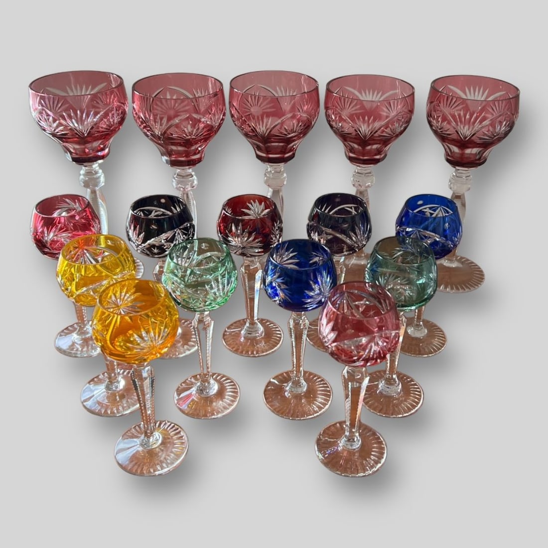 Lot of 16 Bohemian Multicolor Crystal Wine Liquor Goblets: Lot of 16 Bohemian Multicolor Crystal Wine Liquor Goblets . Unsigned. Size Of Small Glass: 5.5" x 2"x 2" ; Size Of Big Glass: 8"x 3"x 3". Bohemian design includes flowers and pinwheels. No cracks nor