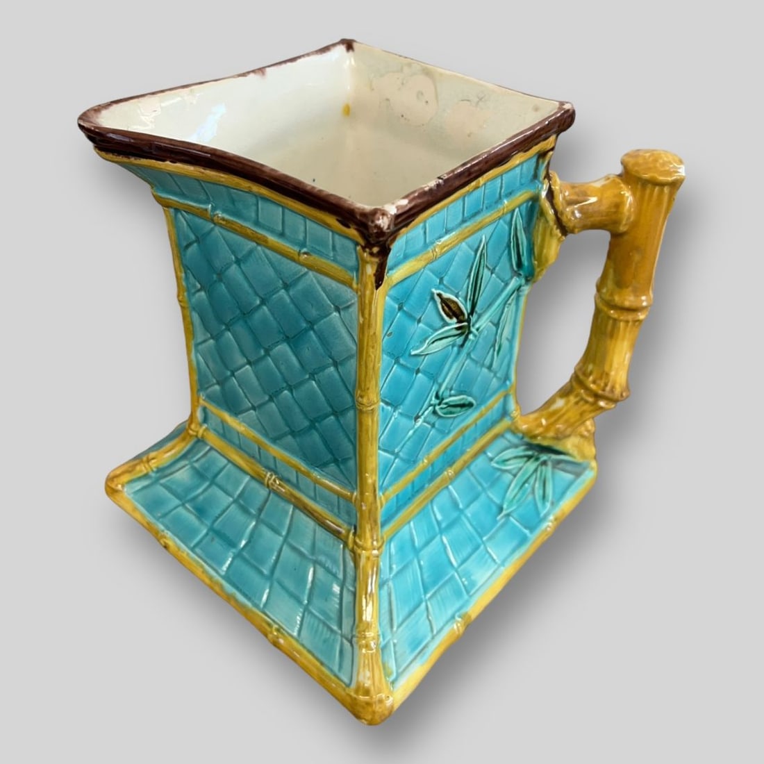 Antique Majolica Tropical Island Themed Porcelain Pitcher: Antique Majolica Tropical Island Themed Porcelain Pitcher. Bamboo shaped handle. Unsigned. No chips or cracks.