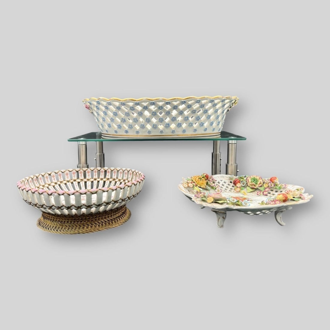 Lot of 3 Reticulated Porcelain Bowls / Dishes: Includes a Meissen (top), Unknown manufacturer (bottom right), & Burk (bottom left). Multiple chips on flowers. Meissen basket is missing handles. Dimensions of the largest one: 3.75" x 15" x 11.25"