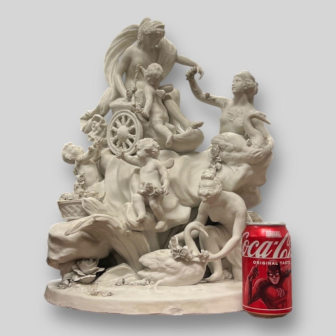 'Aphrodite's Chariot' White Porcelain Sculpture: 'Aphrodite's Chariot' White Porcelain Grouping Sculpture. One cherub is missing a wing & one has a broken finger, also some other minor losses. Dimensions (in): 19 x 15.25 x 11.50