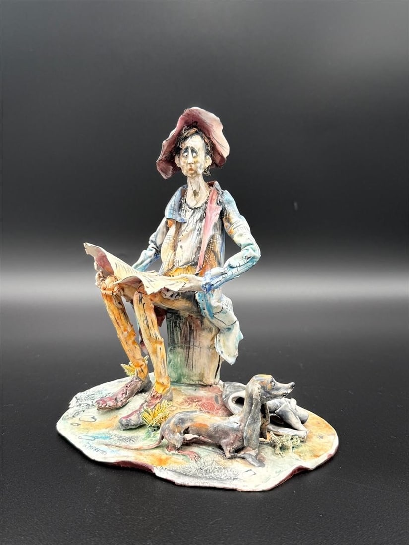 Toni Moretto Seated Man Ceramic Sculpture: Toni Moretto Seated Man Ceramic Sculpture. Lo Scricciolo. Depicts a seated pauper, reading a paper, with a dachshund next to him.Paper label on bottom. Dimensions (in): 8 x 7 x 5.